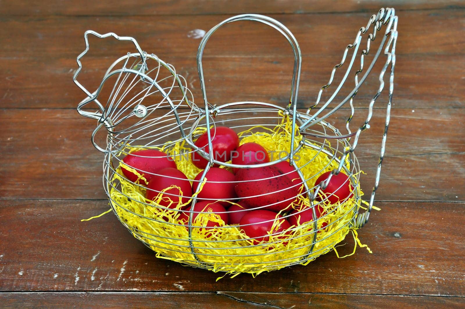 Vintage chicken shaped basket with red painted easter eggs.