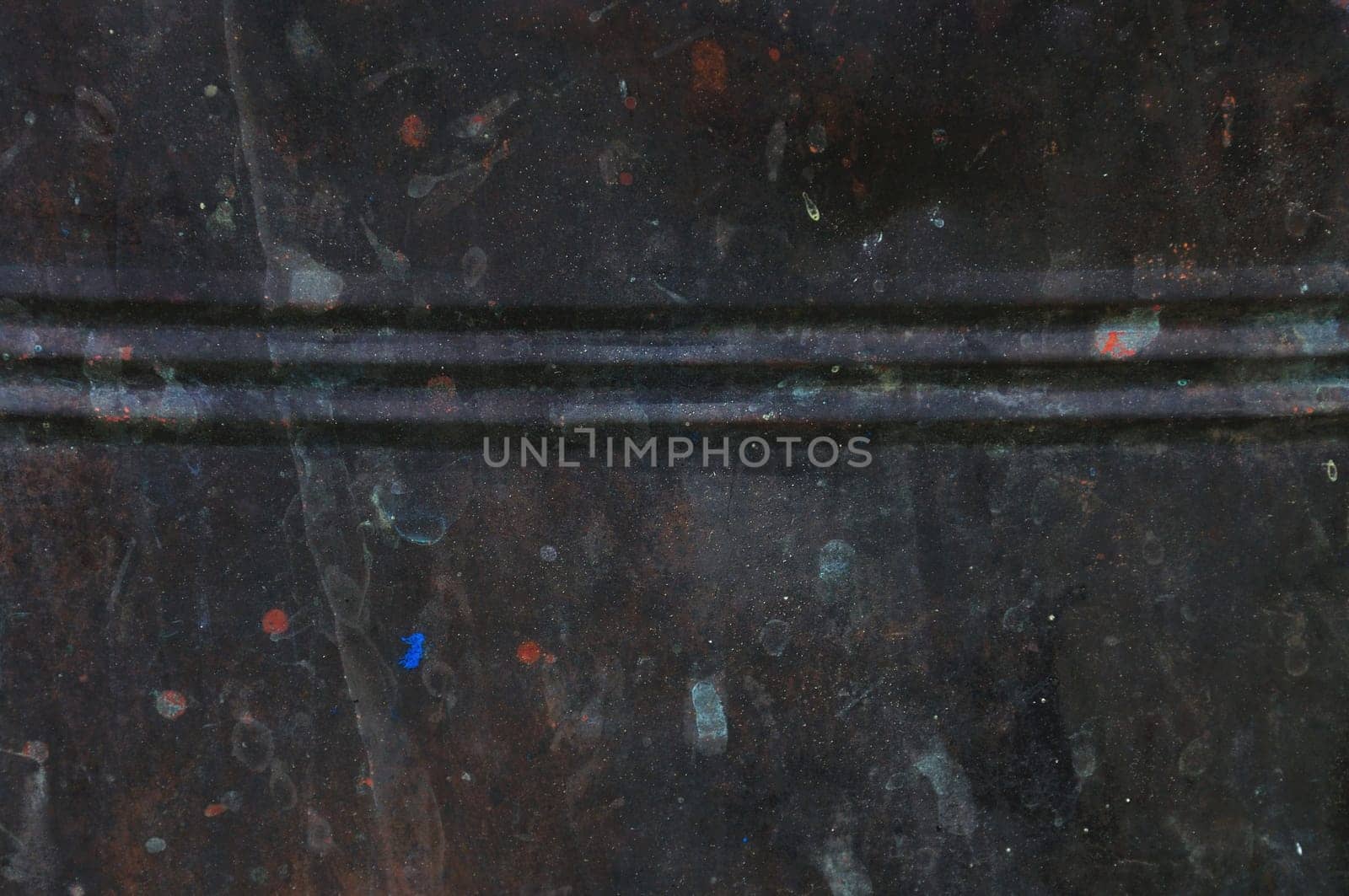 Rusty black barrel background. Paint stained metal texture.