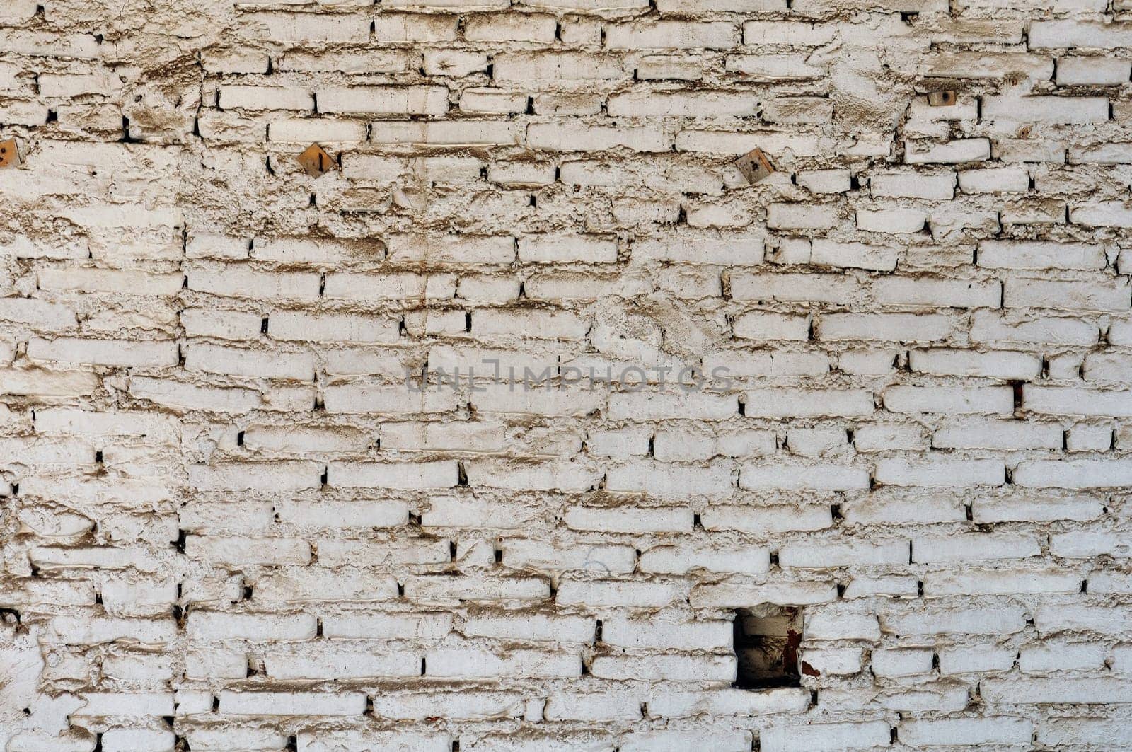 Dirty and weathered white brick wall background texture.