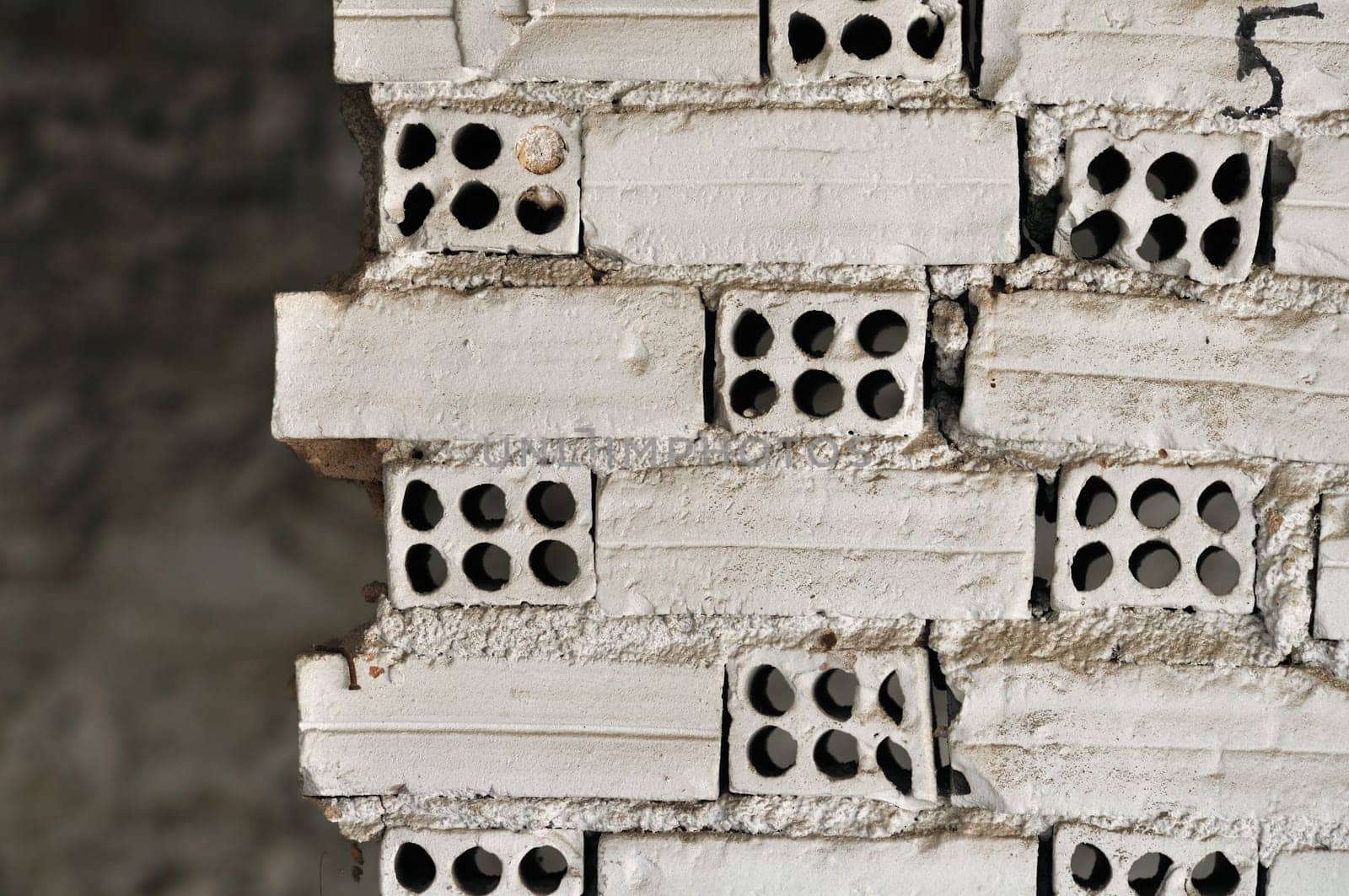 Broken grungy white brick wall background texture.
