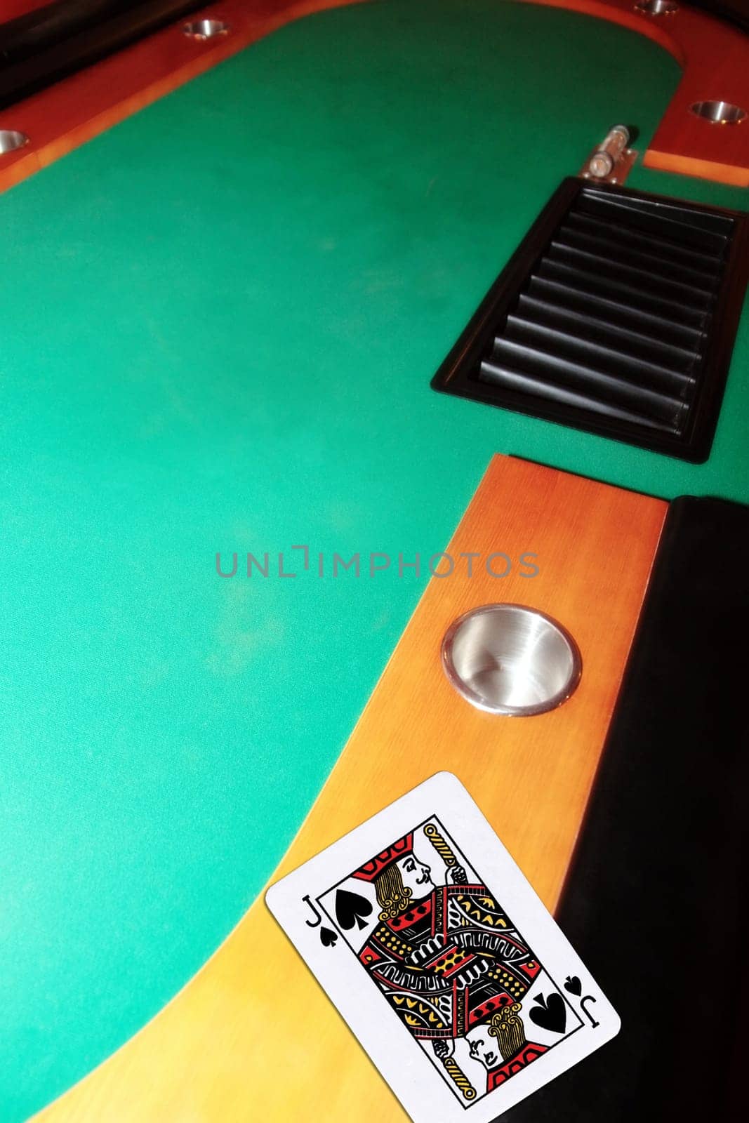 green casino table with copy space and the jack of spades representing a blackjack game