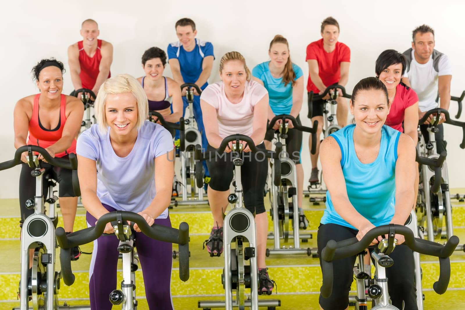 Spinning class group of young people at the gym