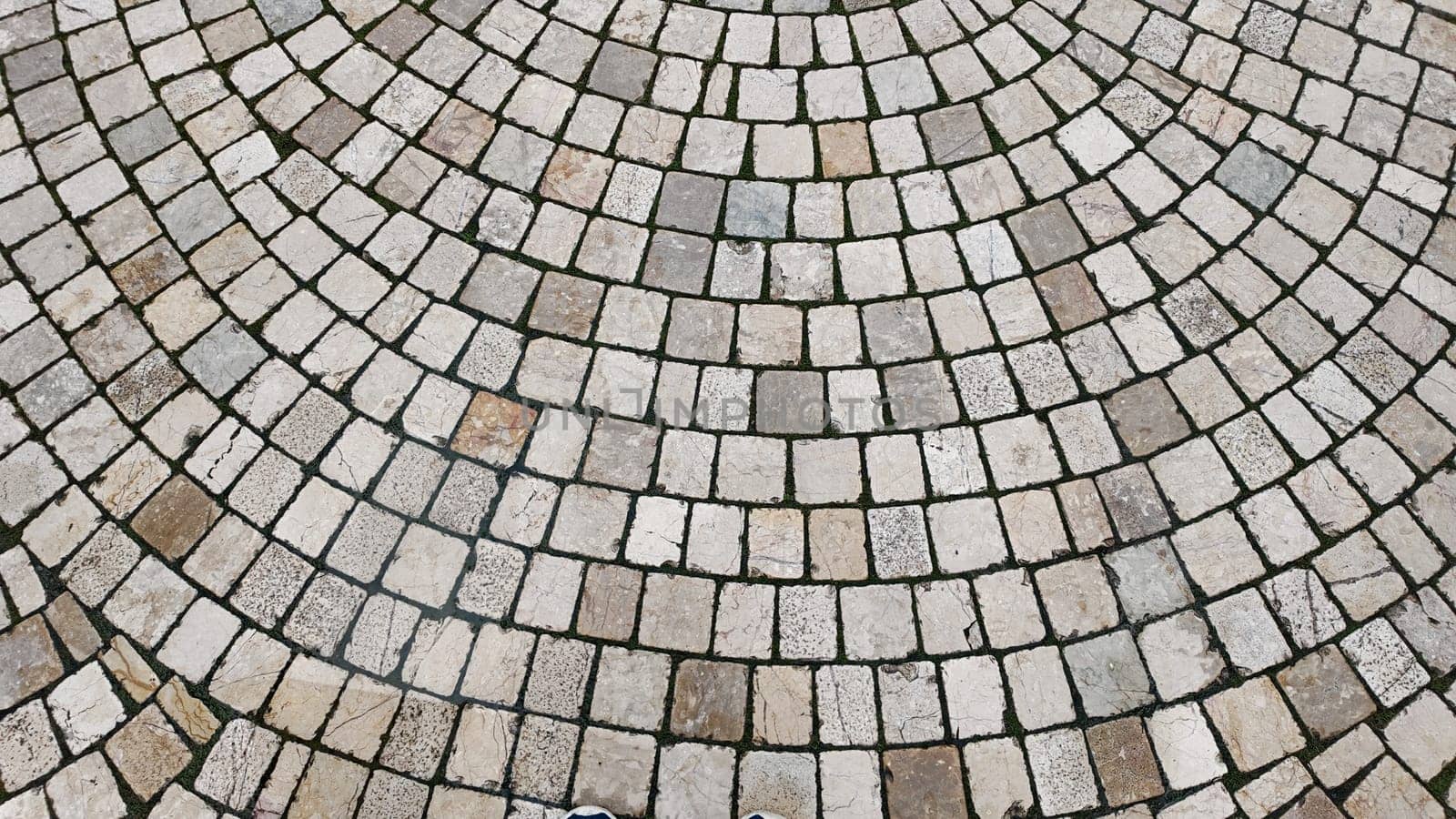 A patterned stone pavement featuring concentric circles in a plaza.