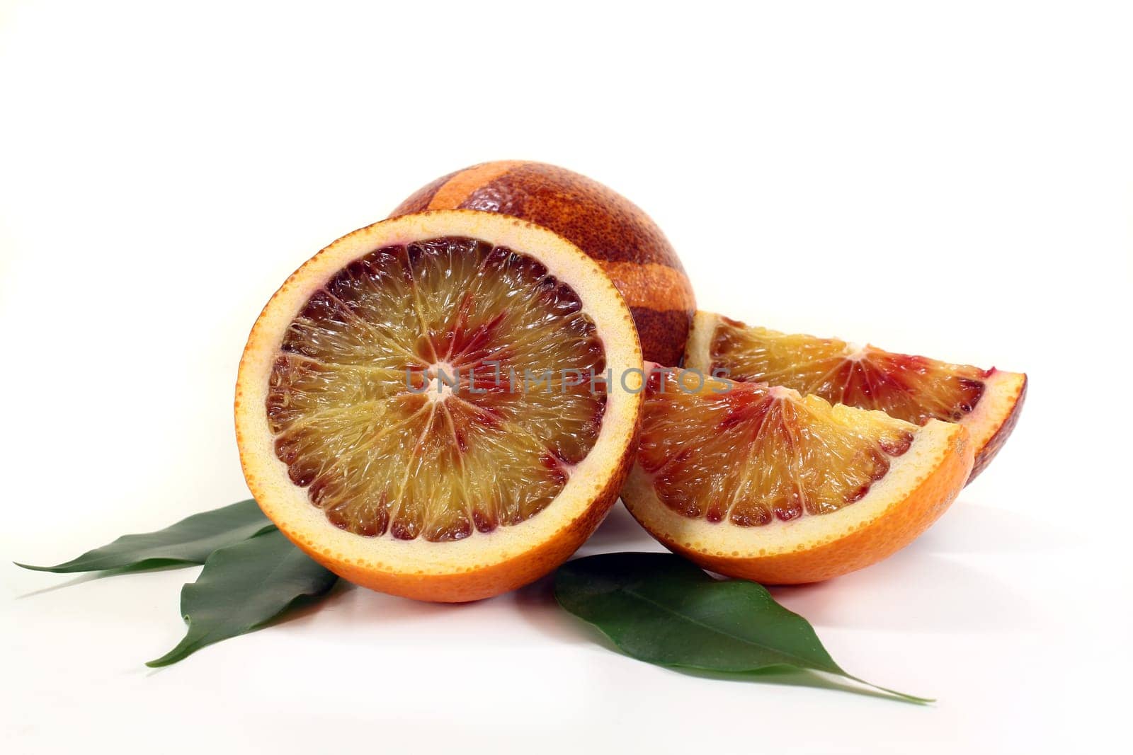 a fresh sliced blood orange against a white background