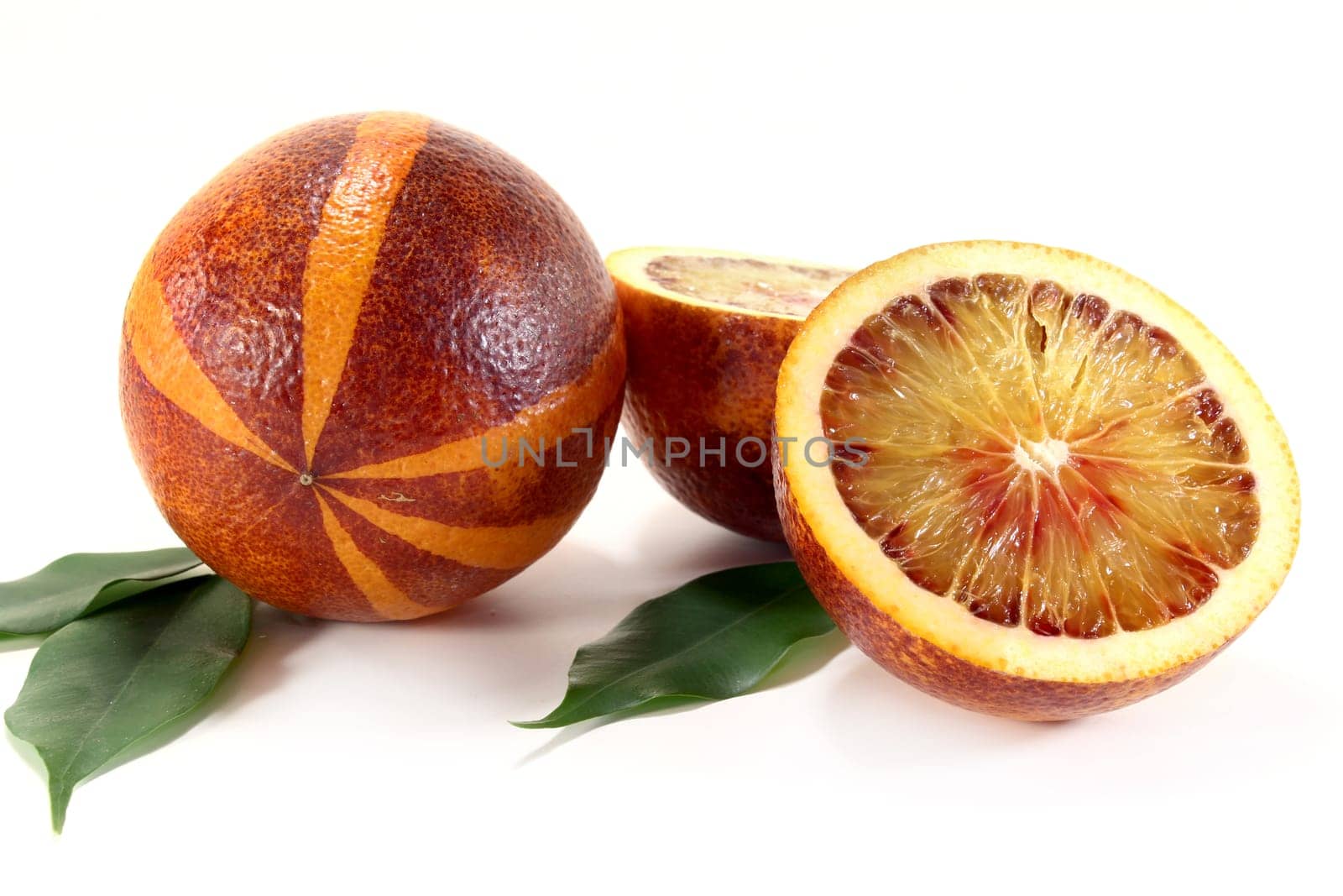 a fresh sliced blood orange against a white background