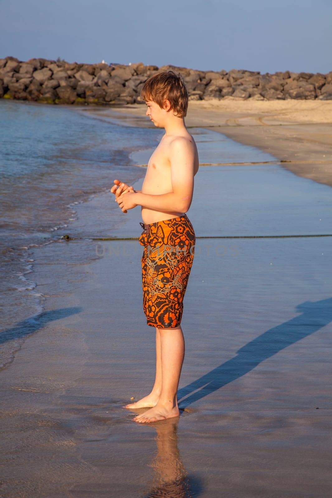 boy enjoys the beach in morning sun