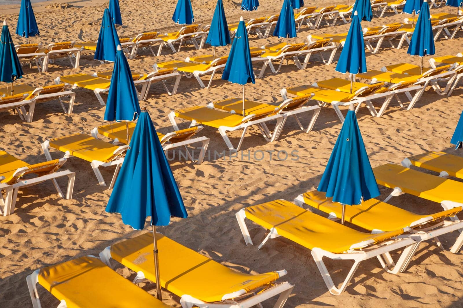 beautiful beach in the morning with beach beds and umbrella