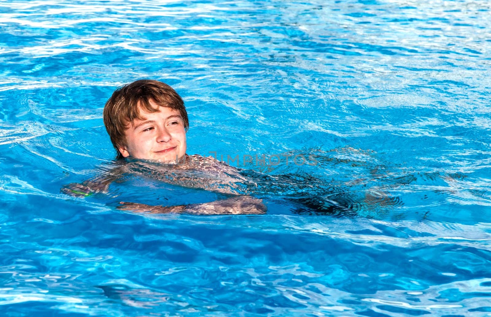 cute boy swimming in the pool