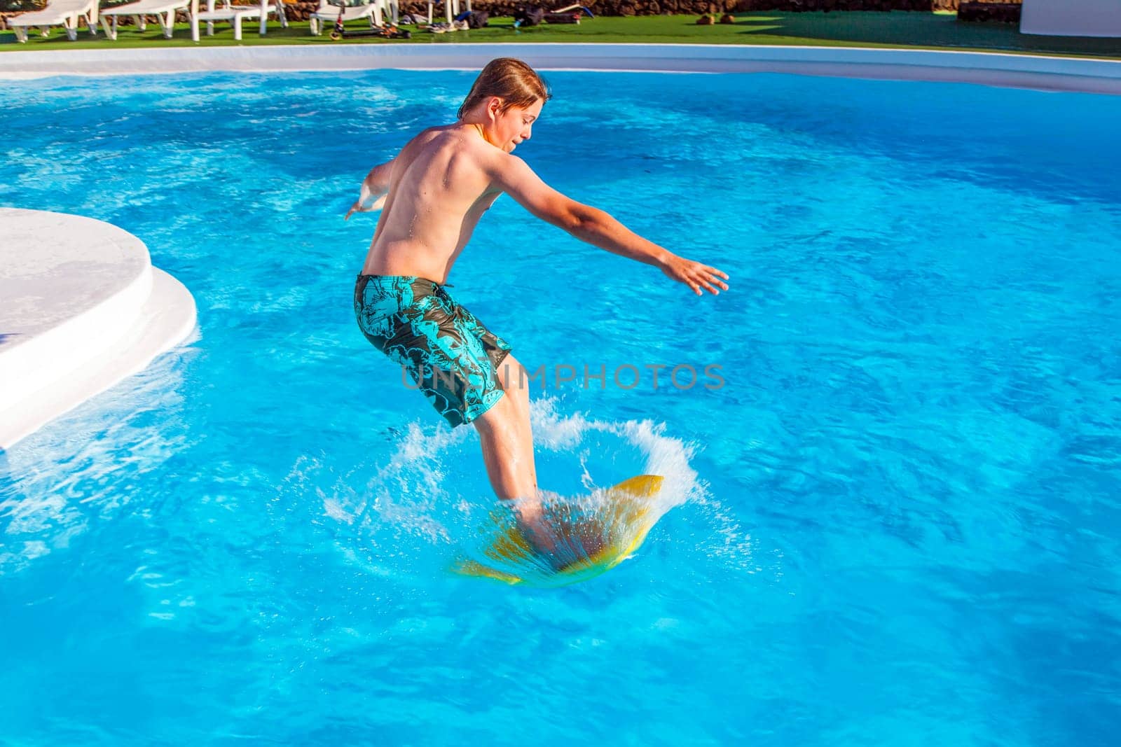 boy has fun jumping in the pool