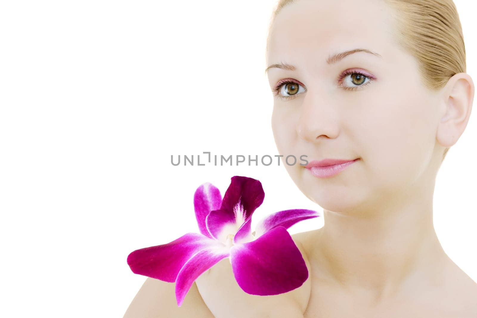 Close-up face of young woman with orchid on white background