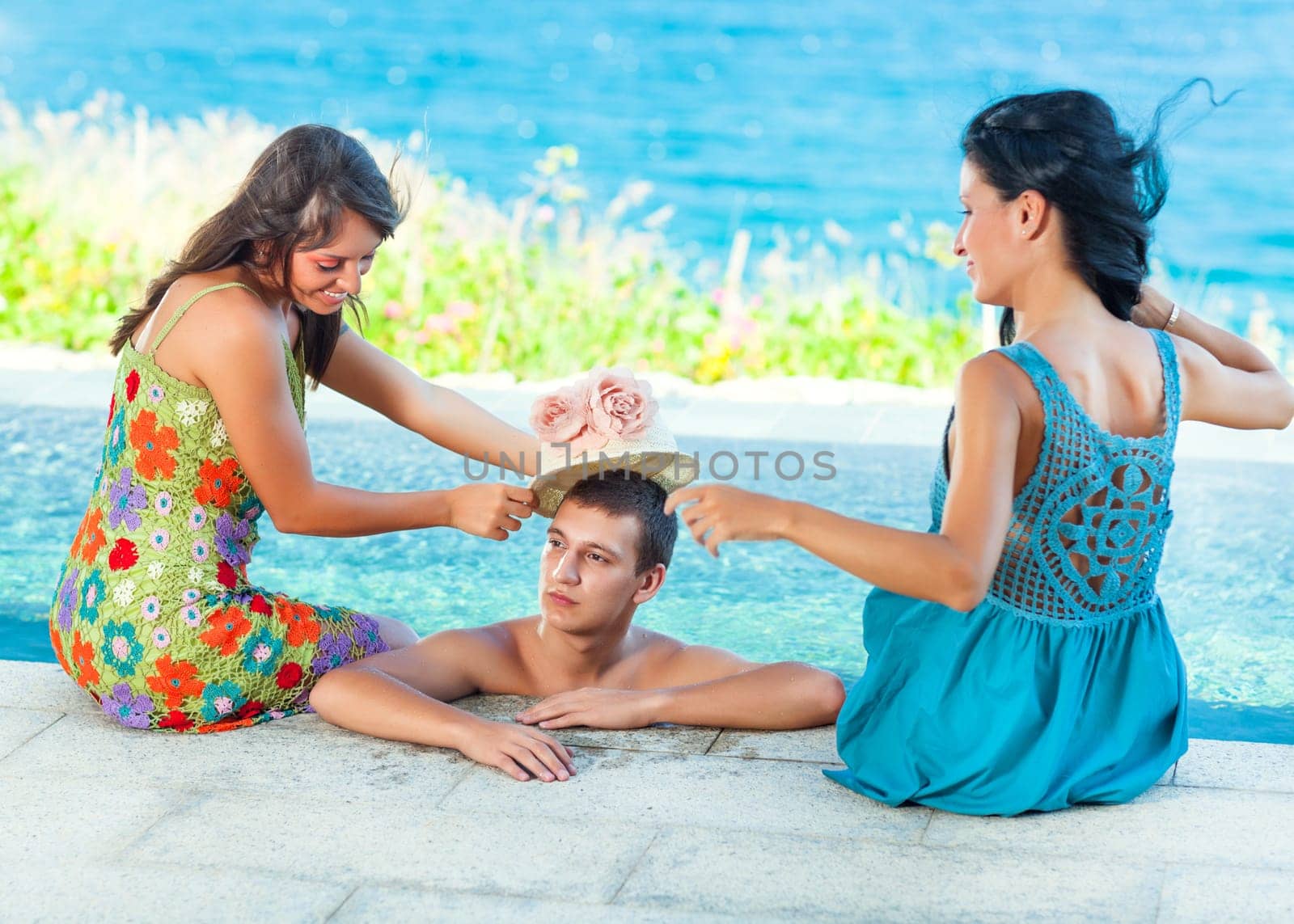 Friends have a fun time in a pool