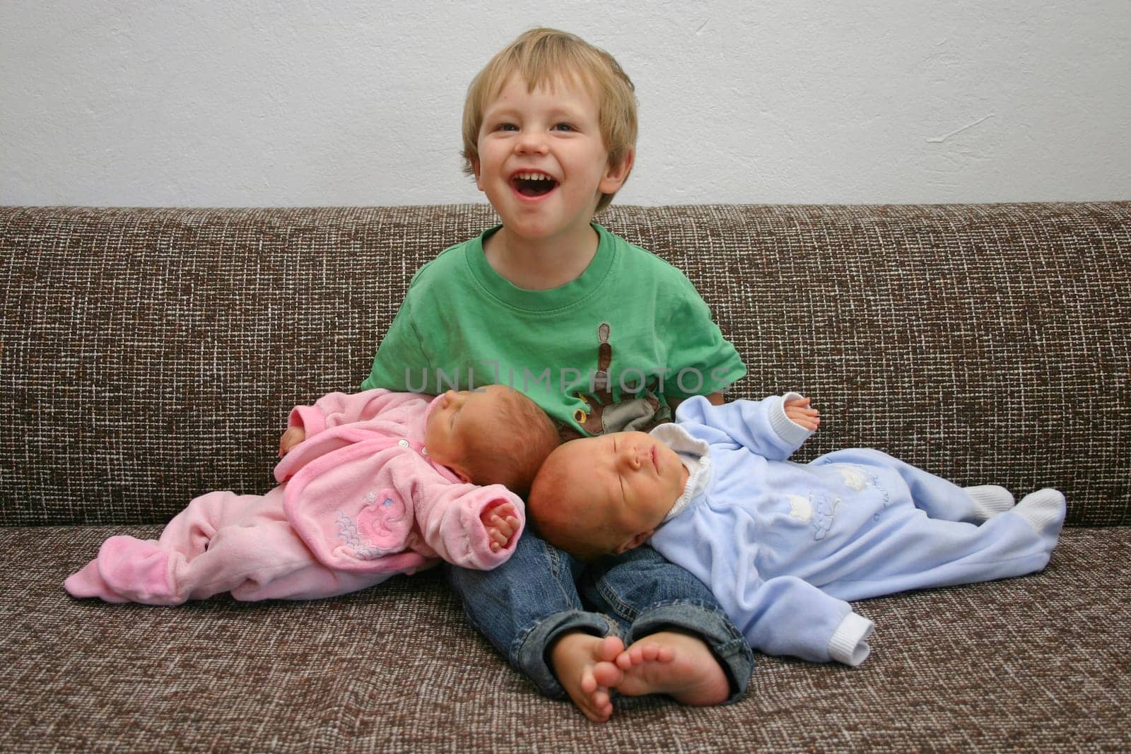 Big proud brother with his siblings on the sofa