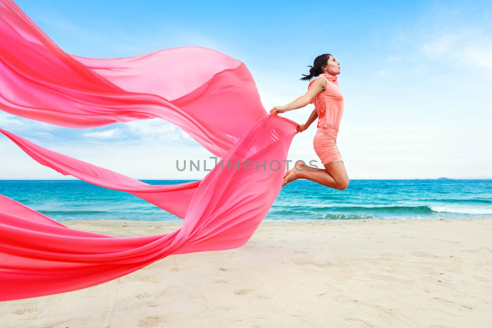 Woman jumping with red scarf
