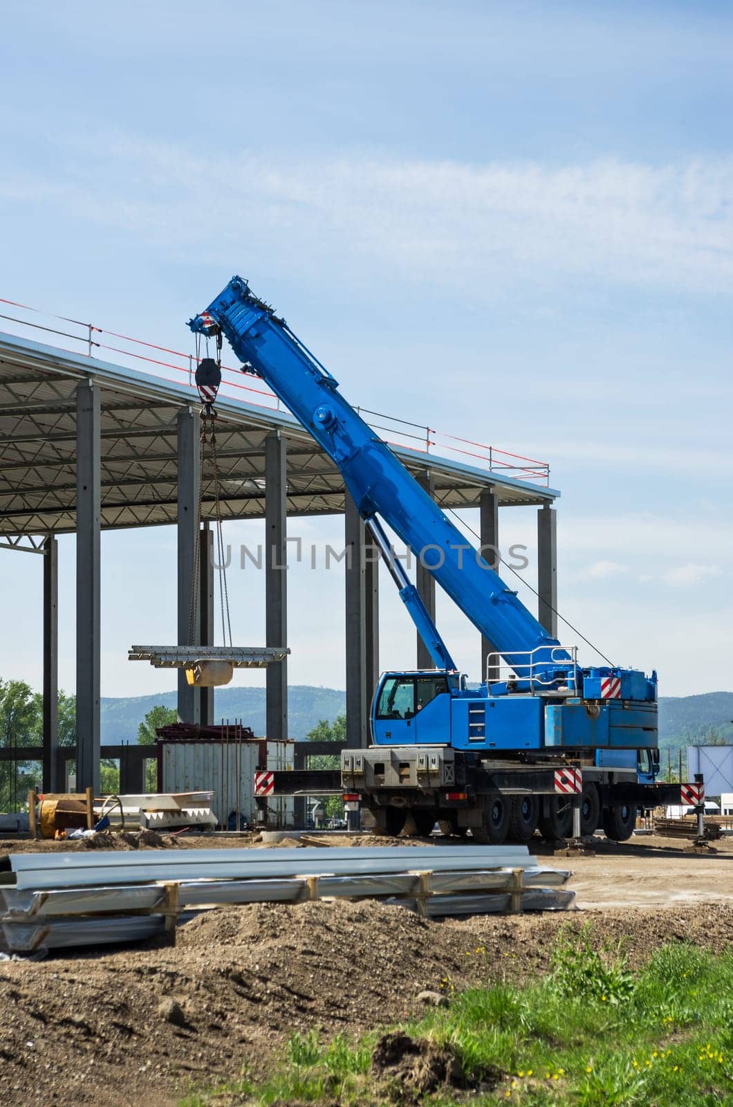 Construction site with blue truck-mounted crane