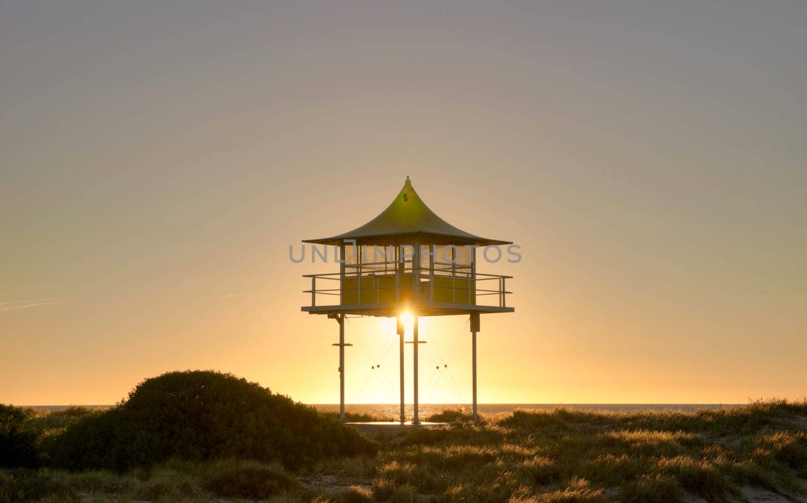 sunset behind surf life savers rescue lookout station
