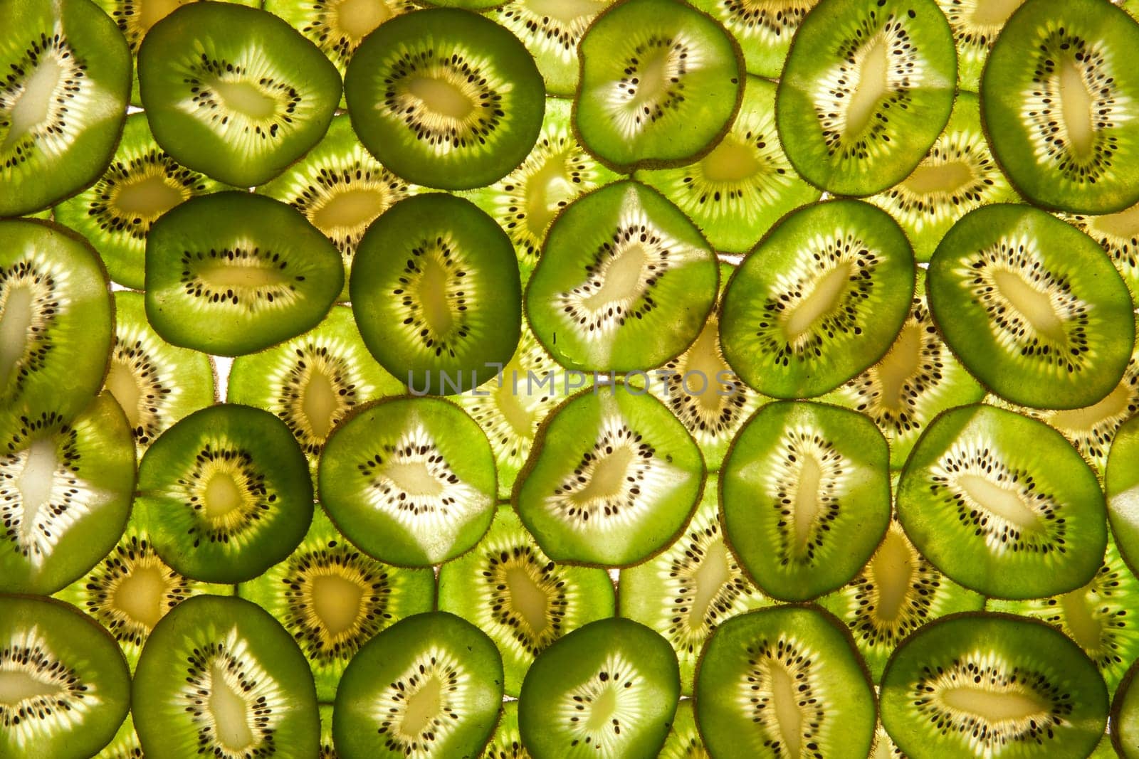 Background laid out in two layers from whole kiwi slices