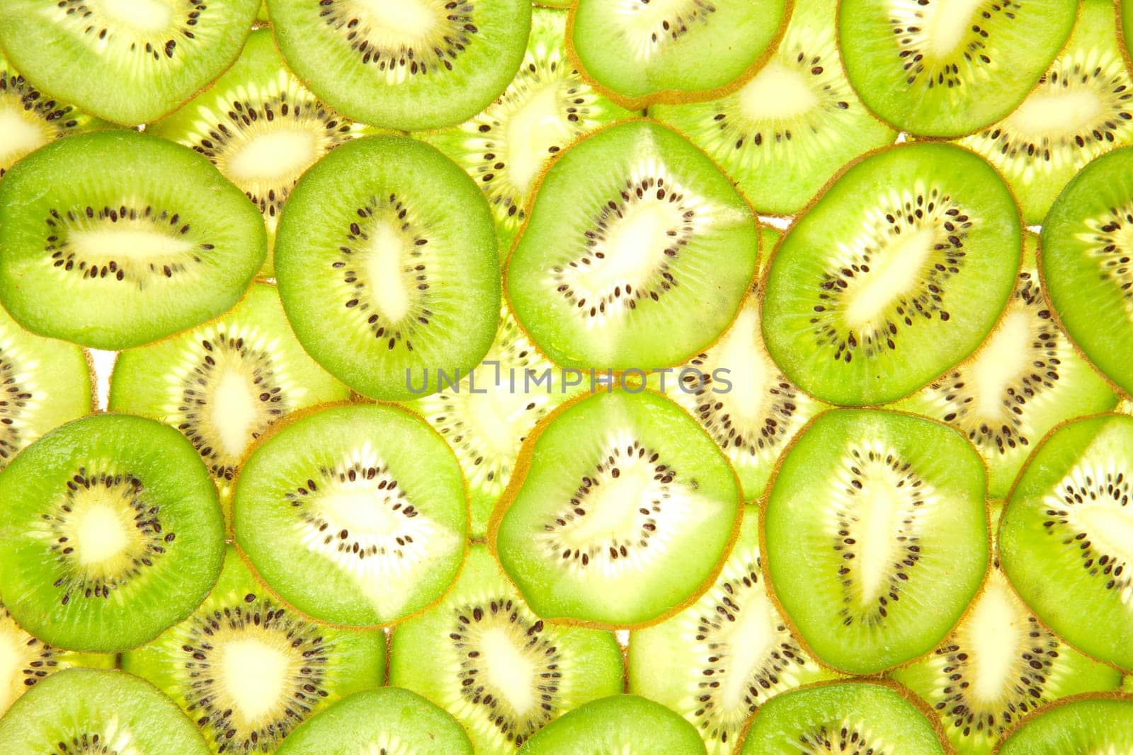 Background laid out in two layers from whole kiwi slices