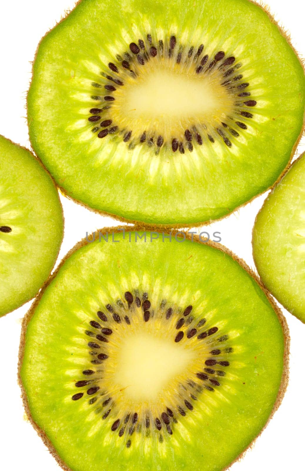 Background of two whole and two quarter kiwi slices