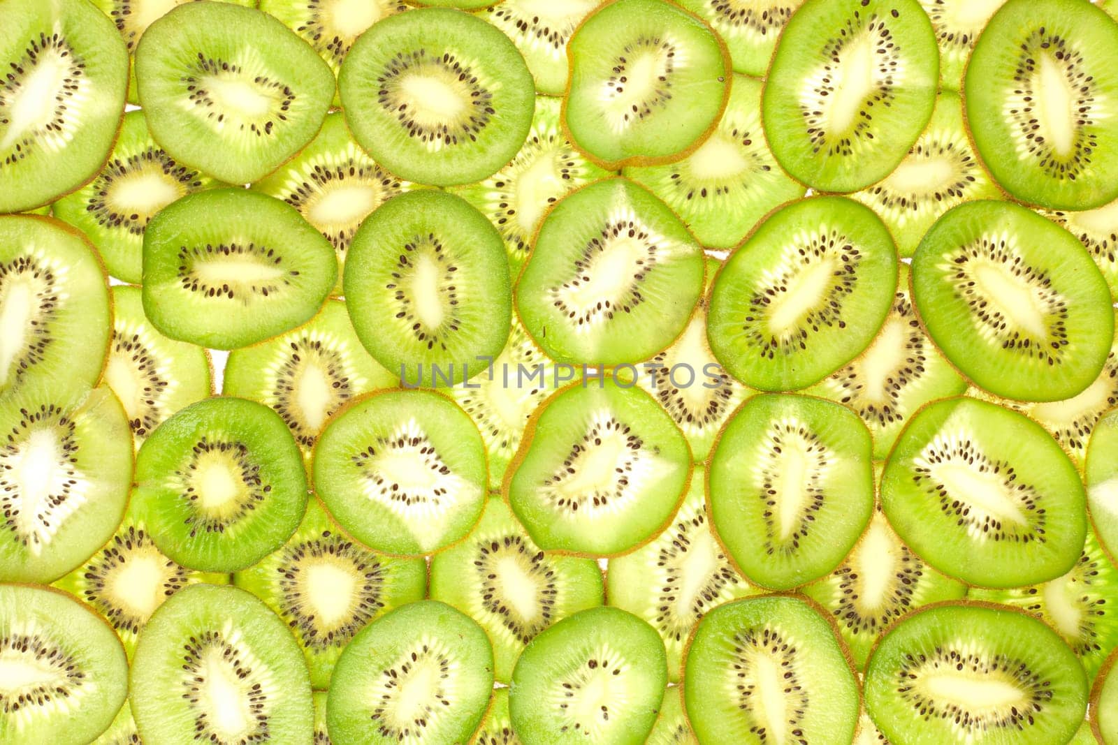 Background laid out in two layers from whole kiwi slices