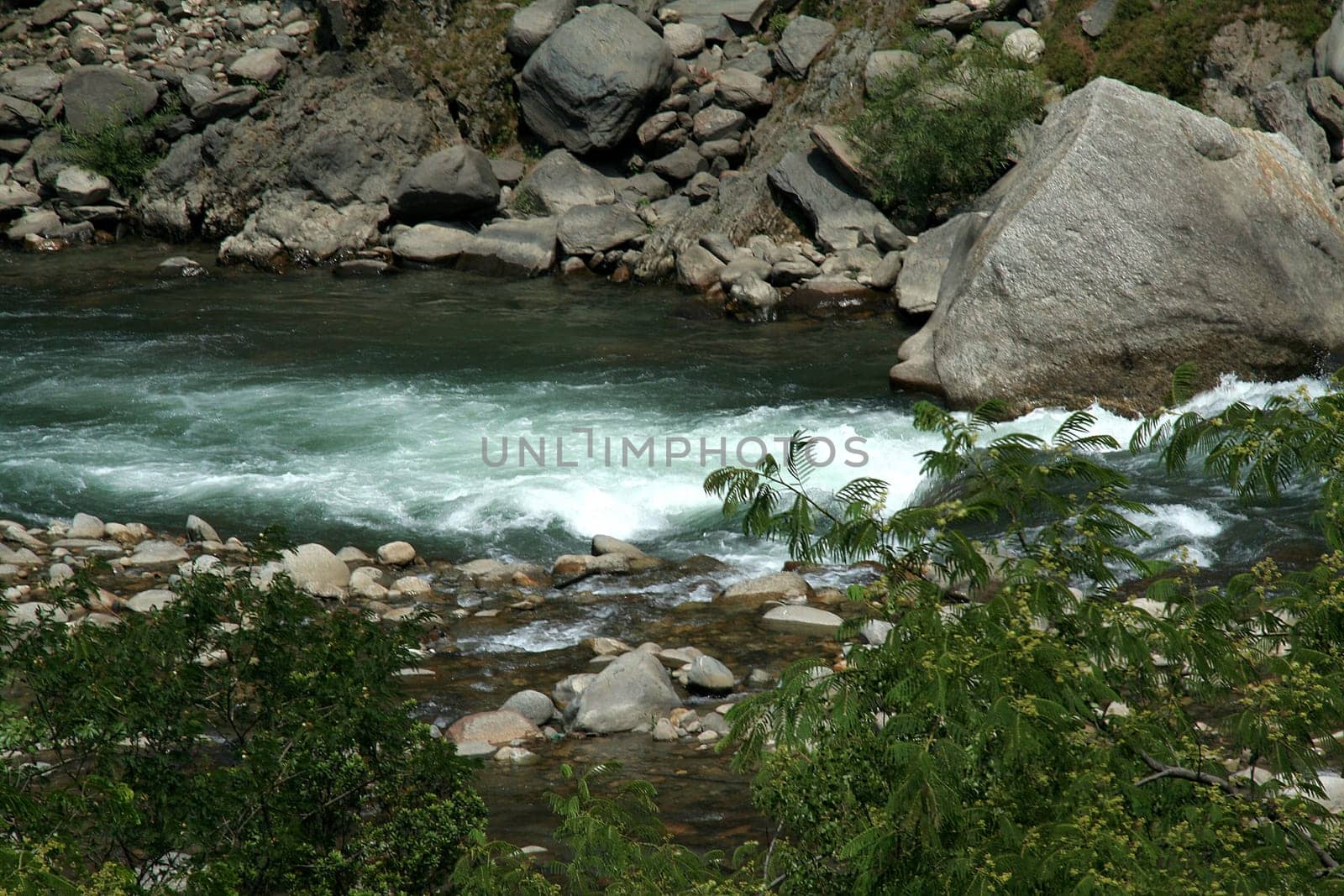 River flowing through boulders, rocks and pebbles
