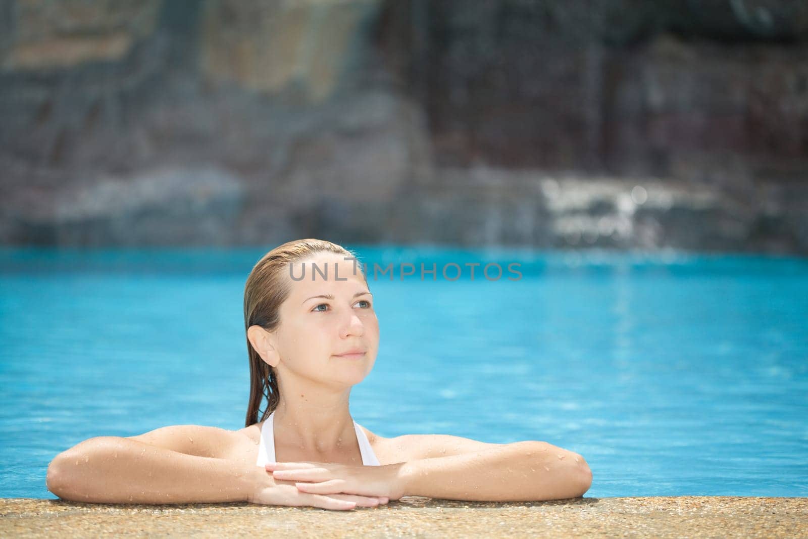 Young woman relaxing in swimming pool outdoor