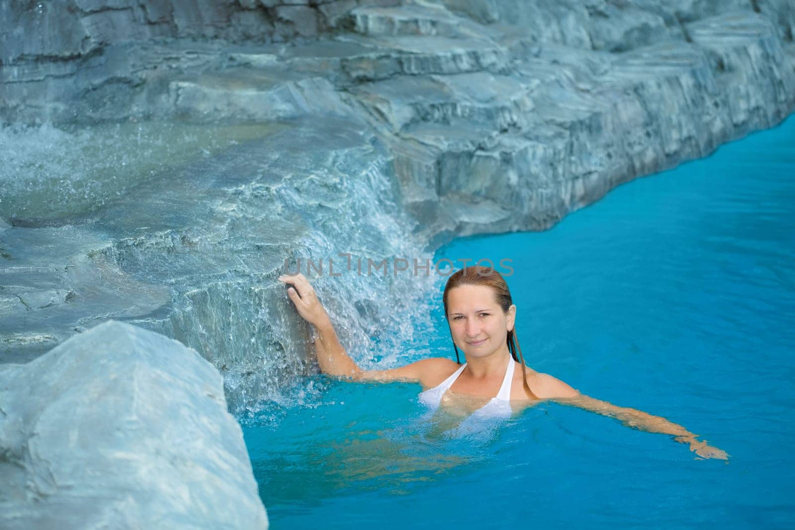 Young woman relaxing in swimming pool outdoor