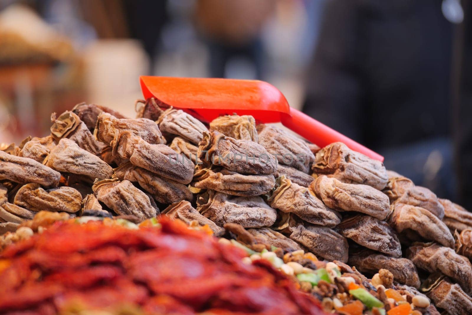 Colorful assortment of dried fruits and nuts attract market visitors.