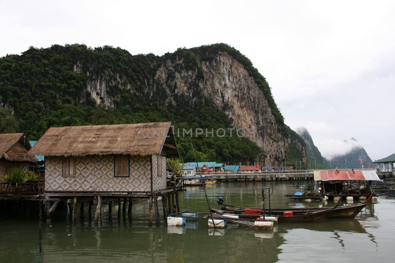 House of fisherman and boat. Ao Phang nga National Park. Koh Panyee. A Muslim "sea gypsy"" fishing village."