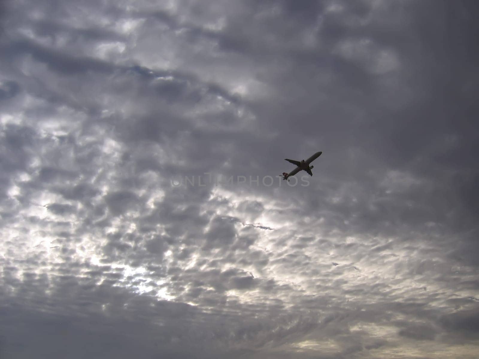 airplane and colorful sunset sky with clouds