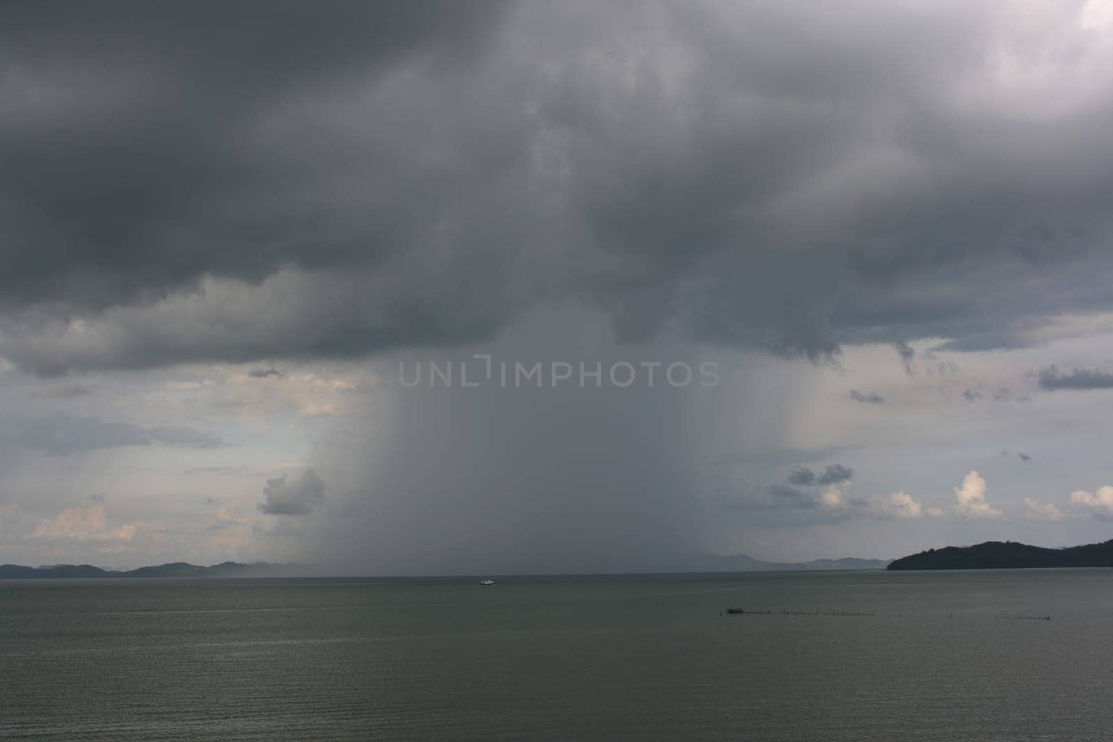 Downpour in the sea seen from a coast
