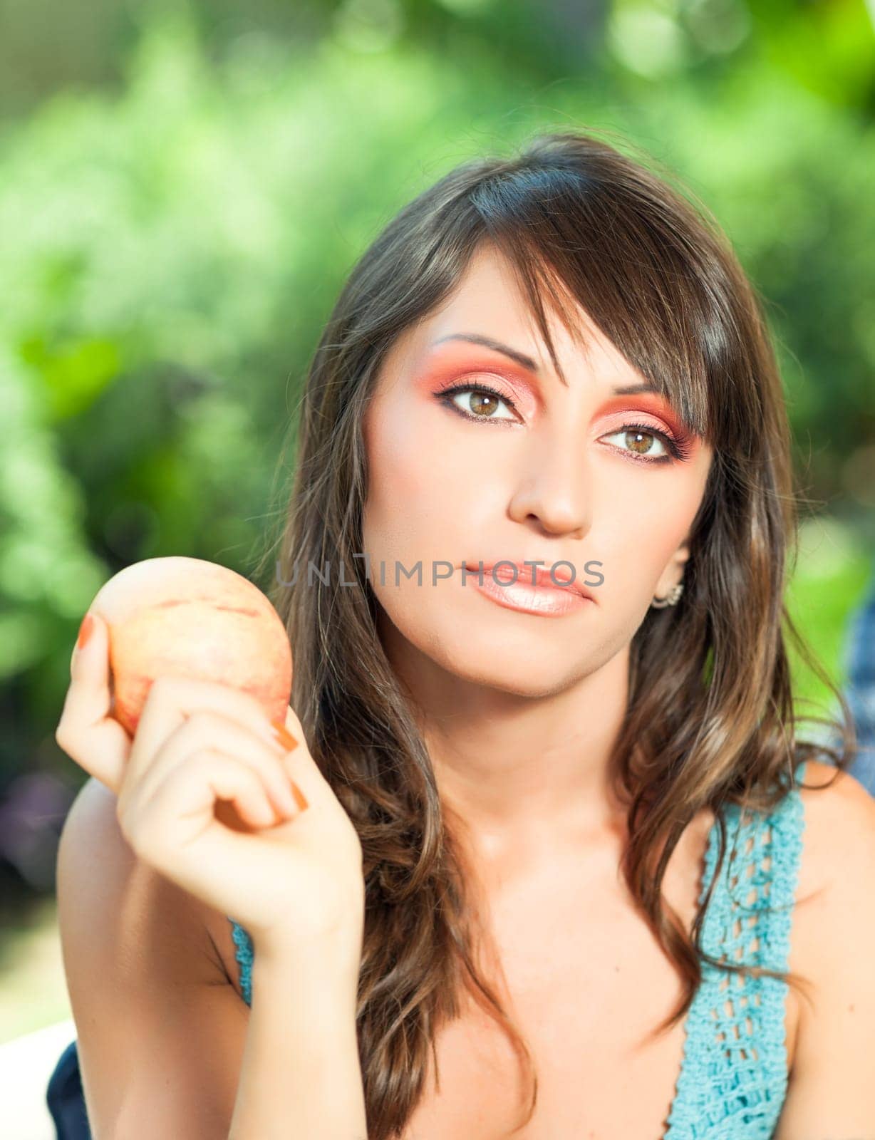 Beautiful woman with apple outdoor