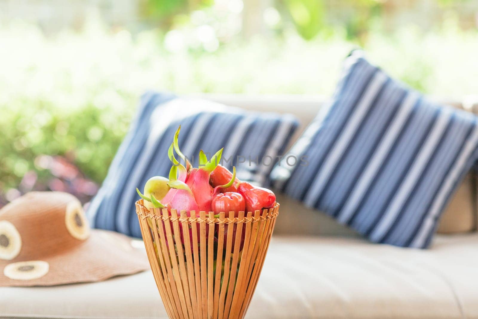 Fruits in basket. Pillows on background
