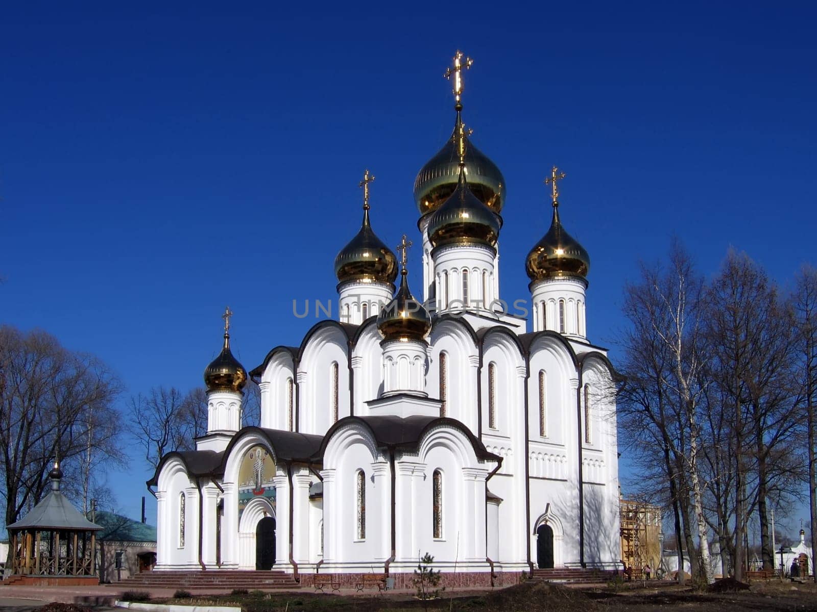 Christian church with the gilt domes on a background of the blue sky