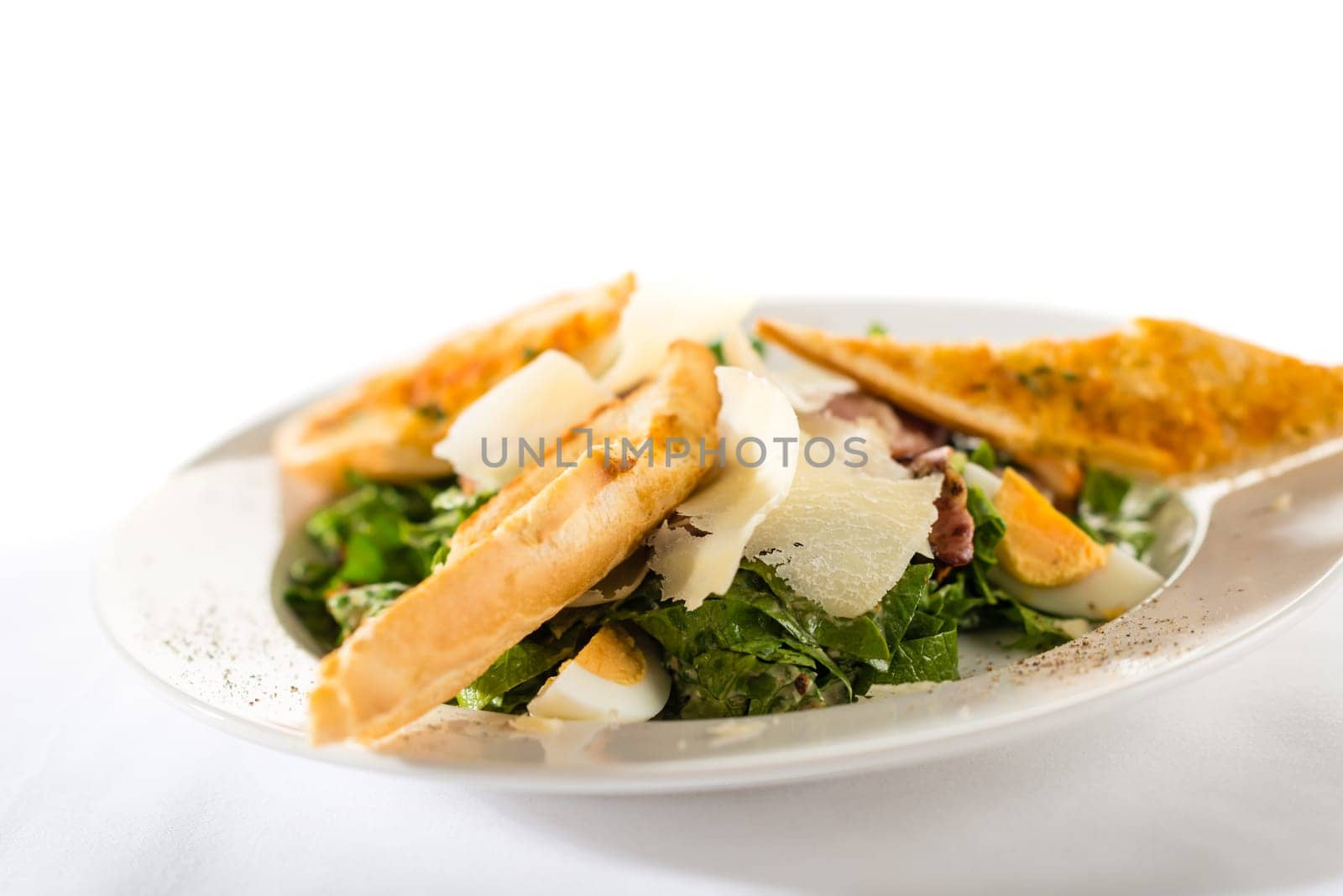 Greek style salad with garlic bread, egg, parmesan and bacon
