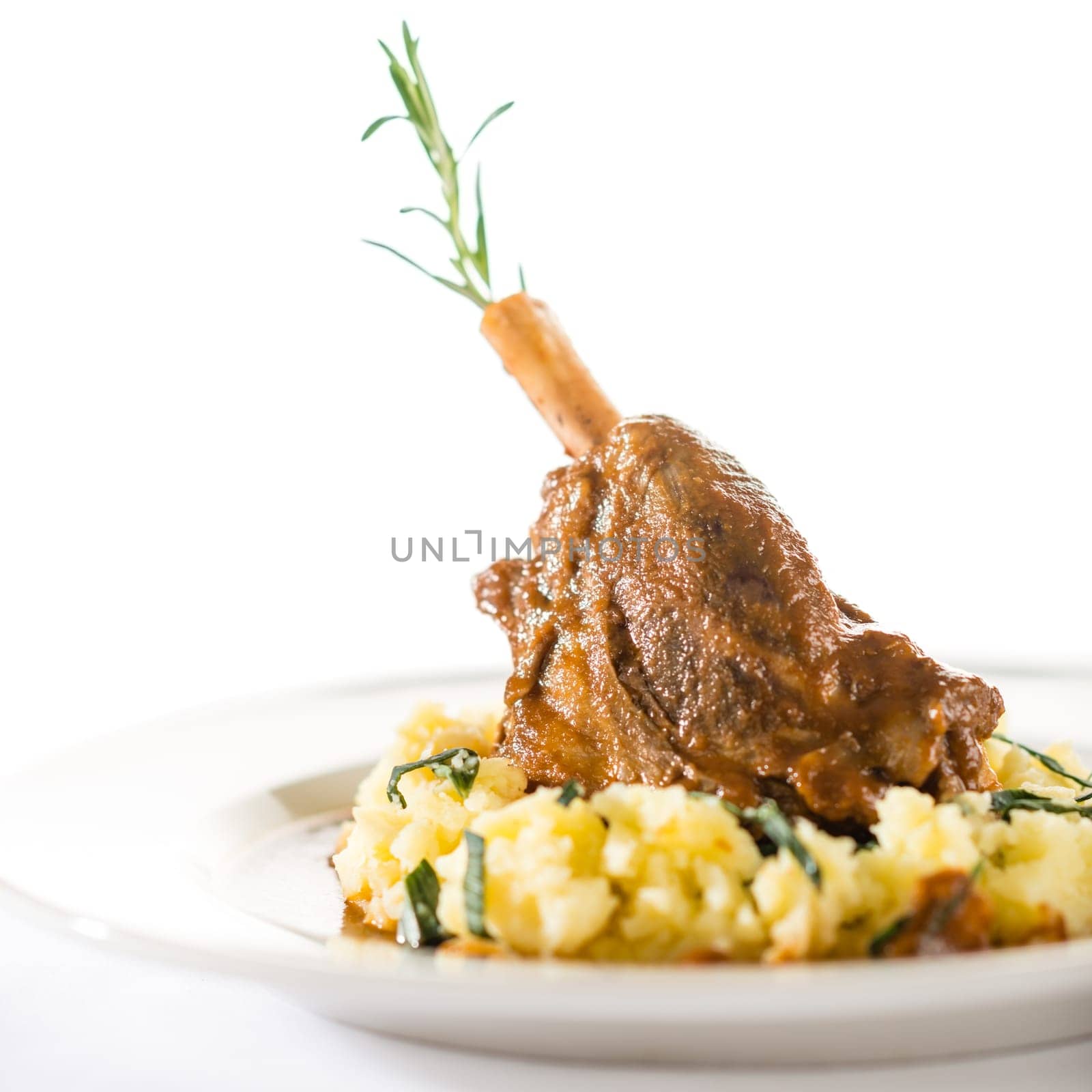 Lamb knee in sauce with mashed potatoes isolated on white