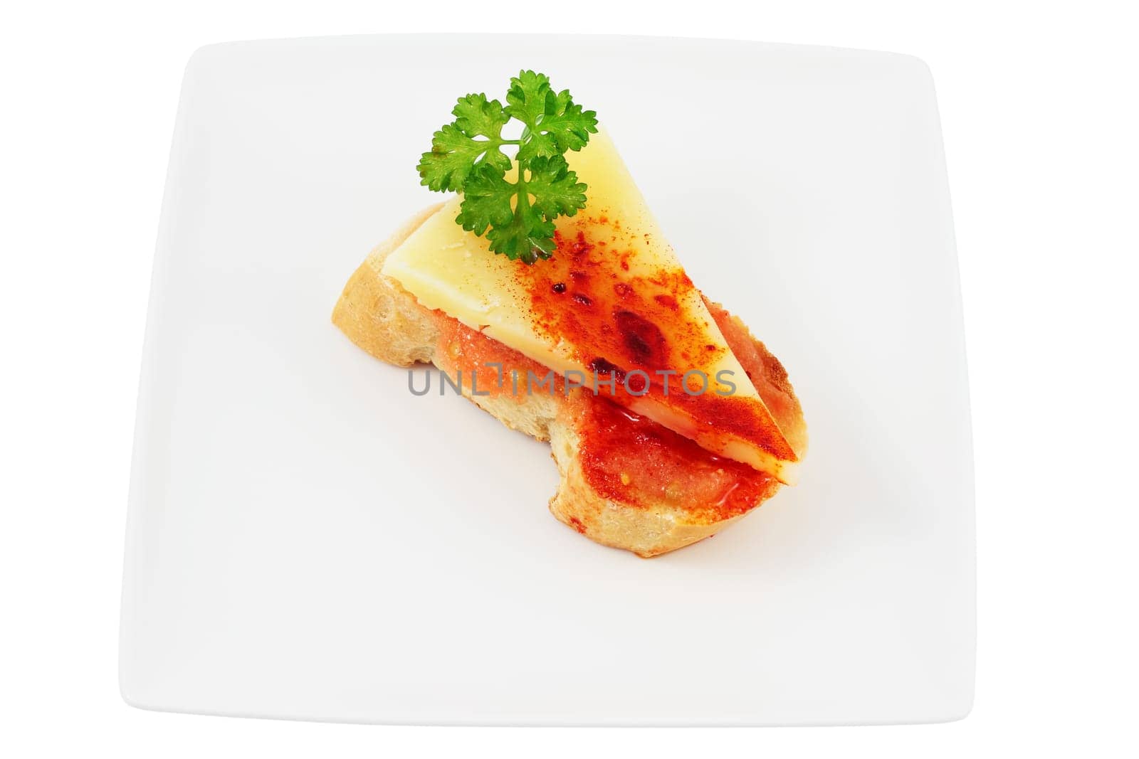 dish of sheep&#039 s cheese with tomato and paprika with olive oil and parsley cut isolated