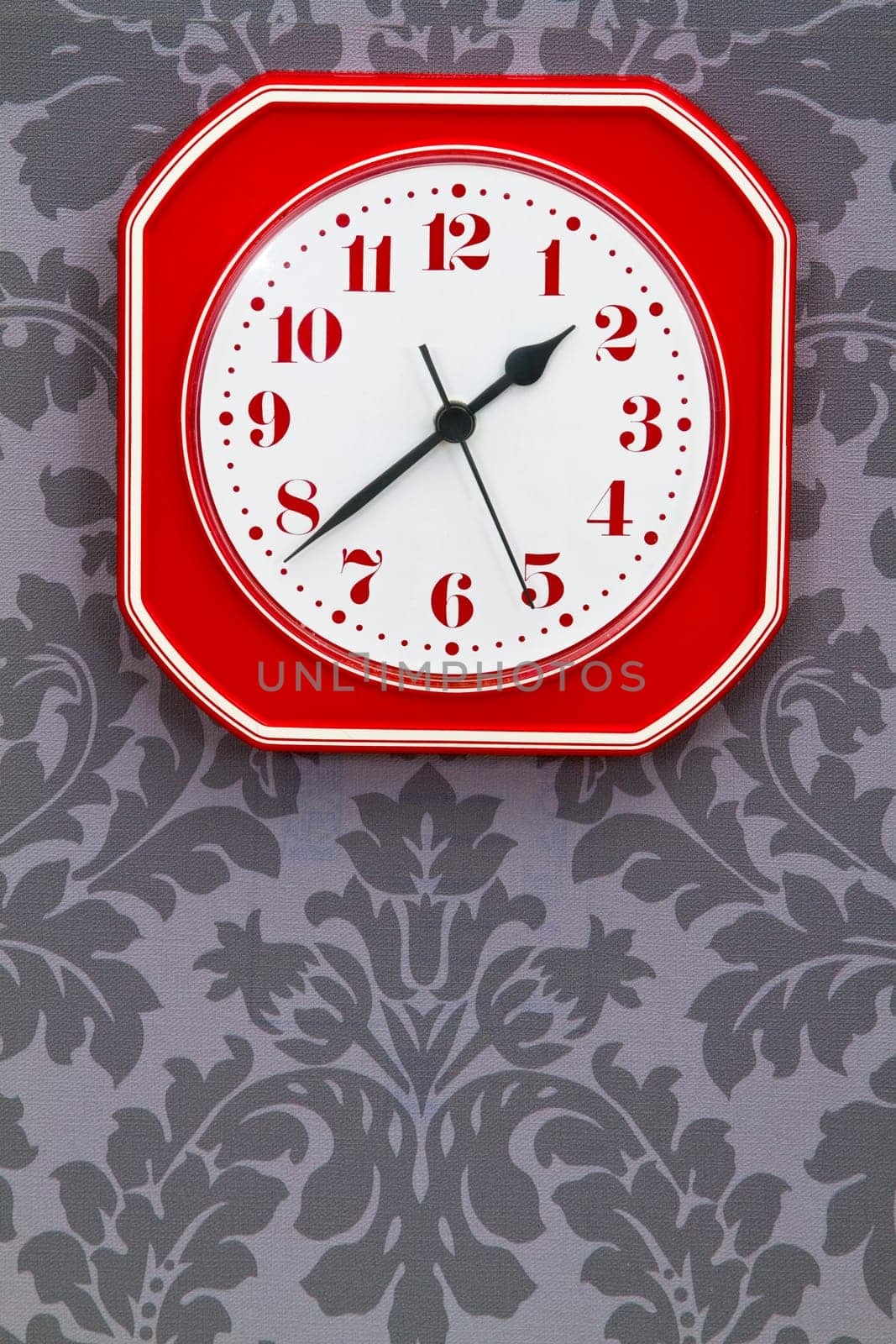 Retro clock on floral wallpaper