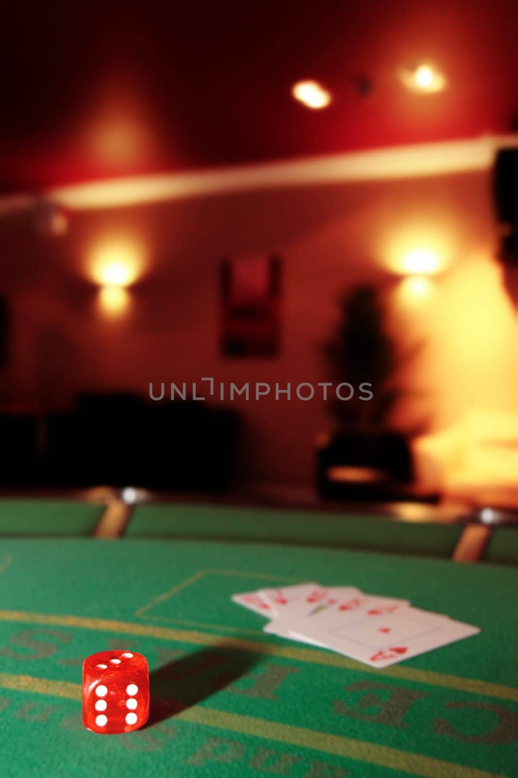 green casino table with dice and a hand of a royal flush in a poker game