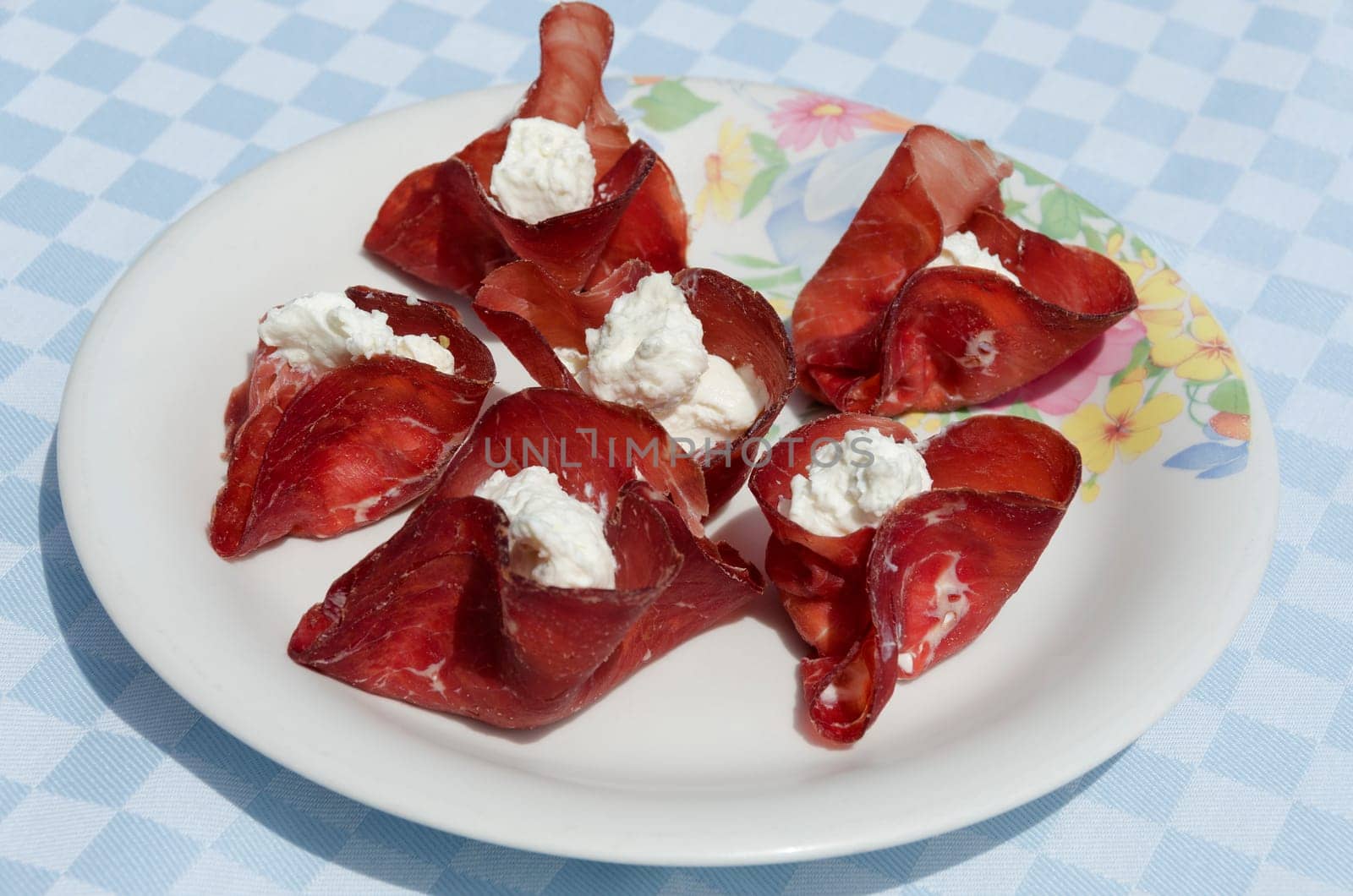 appetizer with slices of dried beef stuffed with cheese