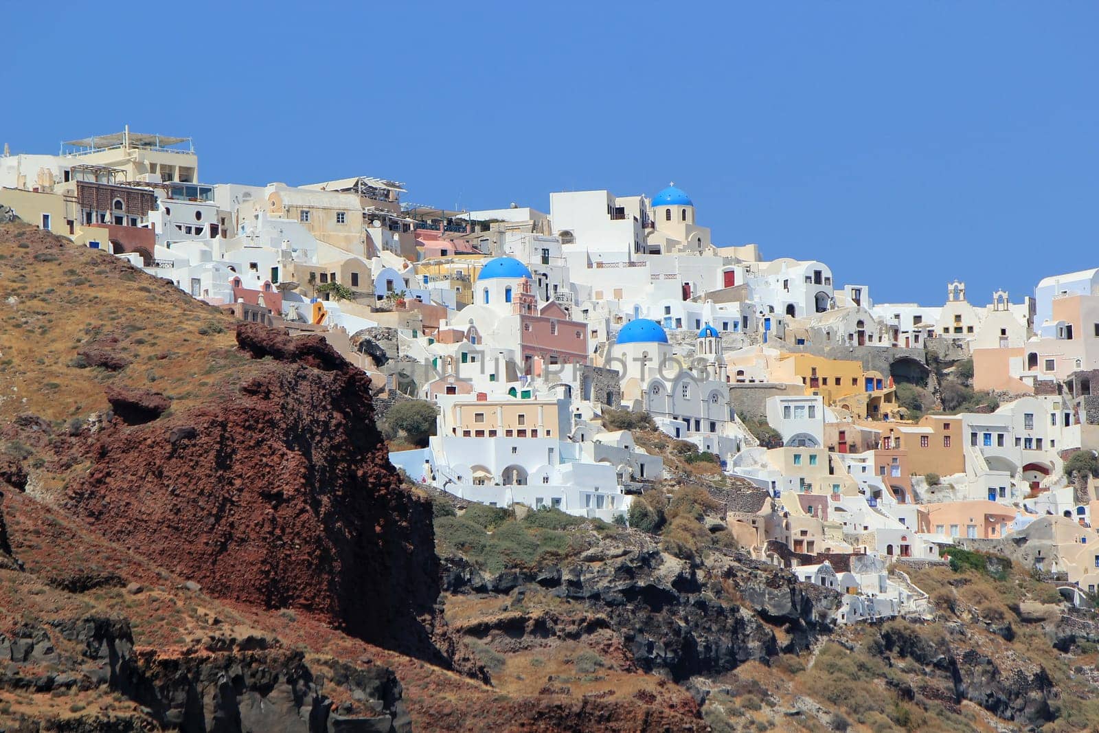 View on the caldera with the blue domes of orthodox churches in Oia, Santorini island, Greece