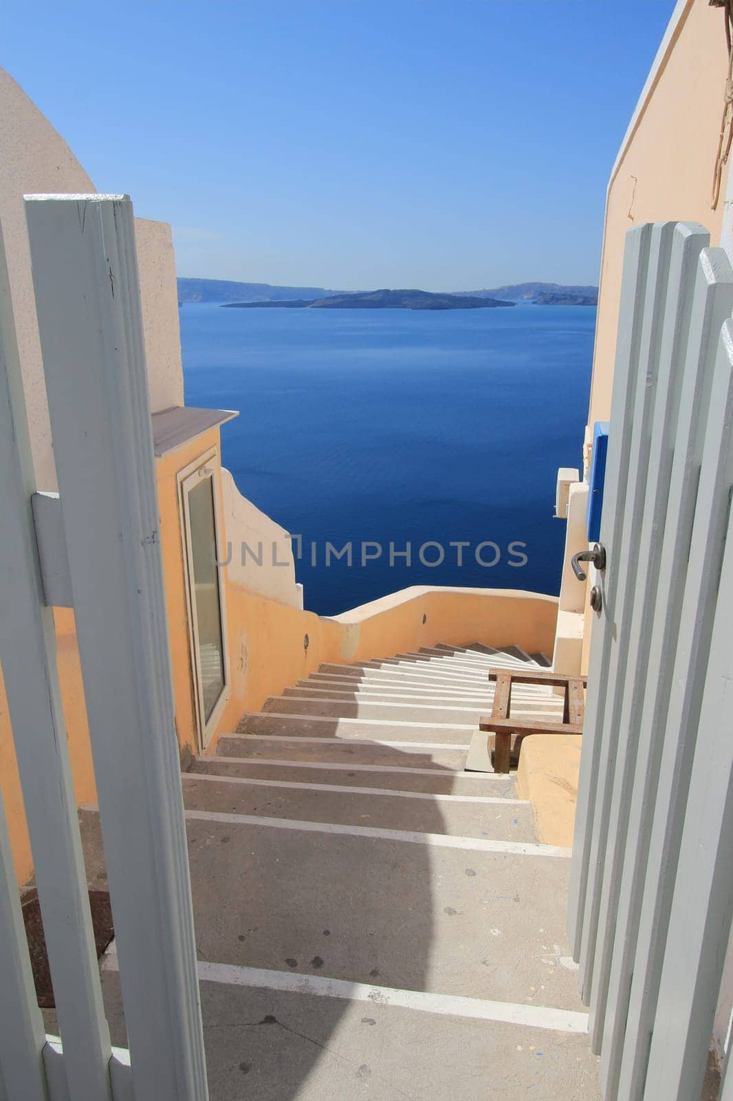 View on Aegean sea, islands and volcano from stairs on Santorini, Greece, by beautiful weather