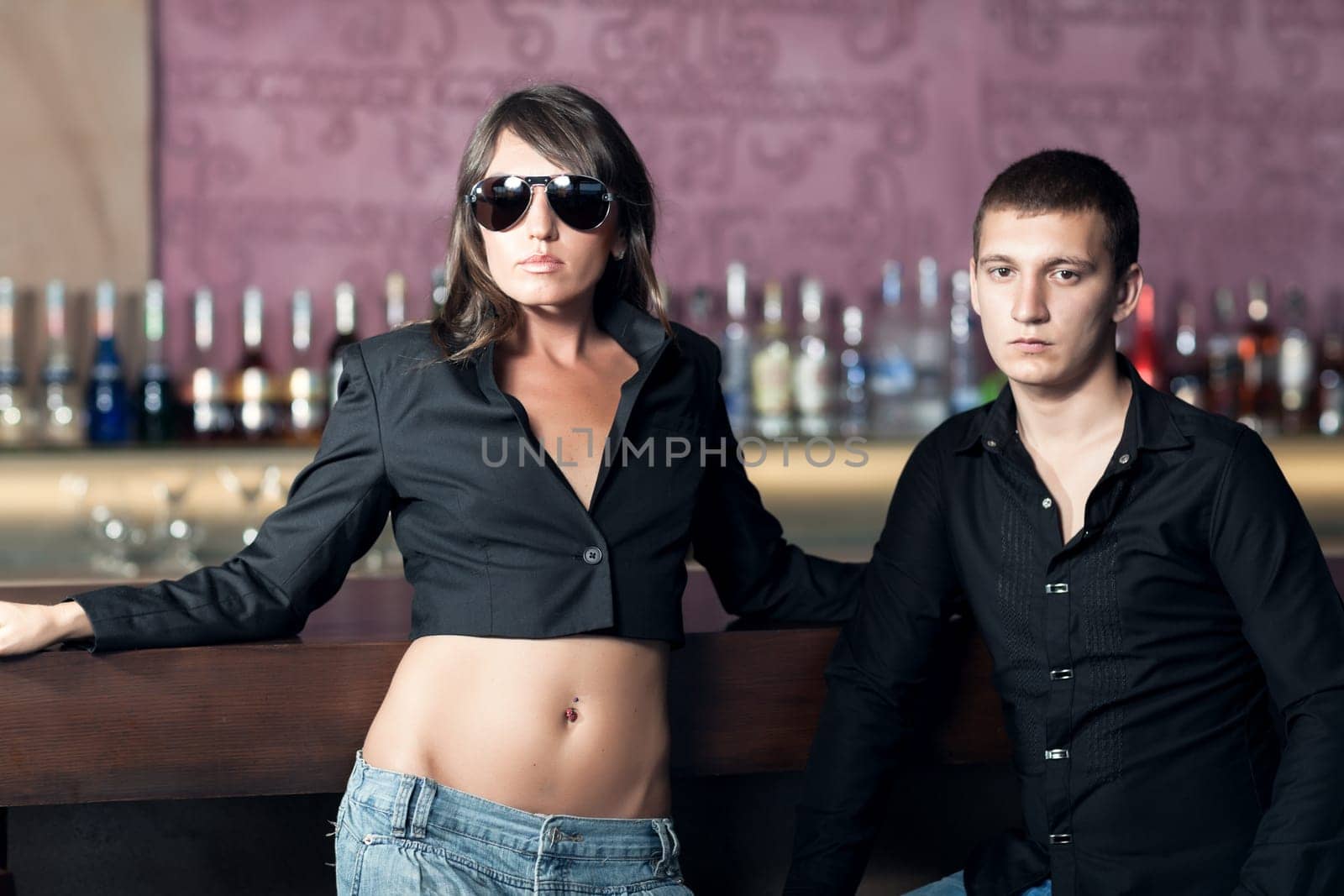 Fashion style photo of a couple in the bar