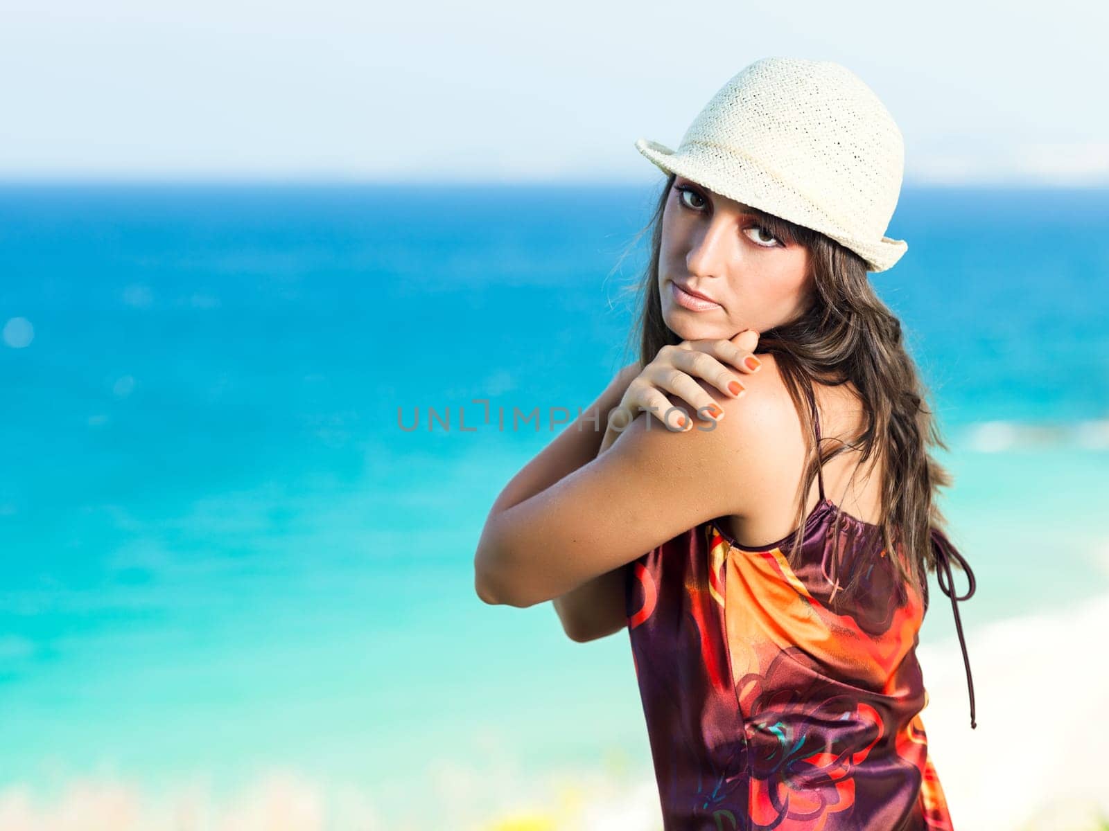 Woman with hat near the pool