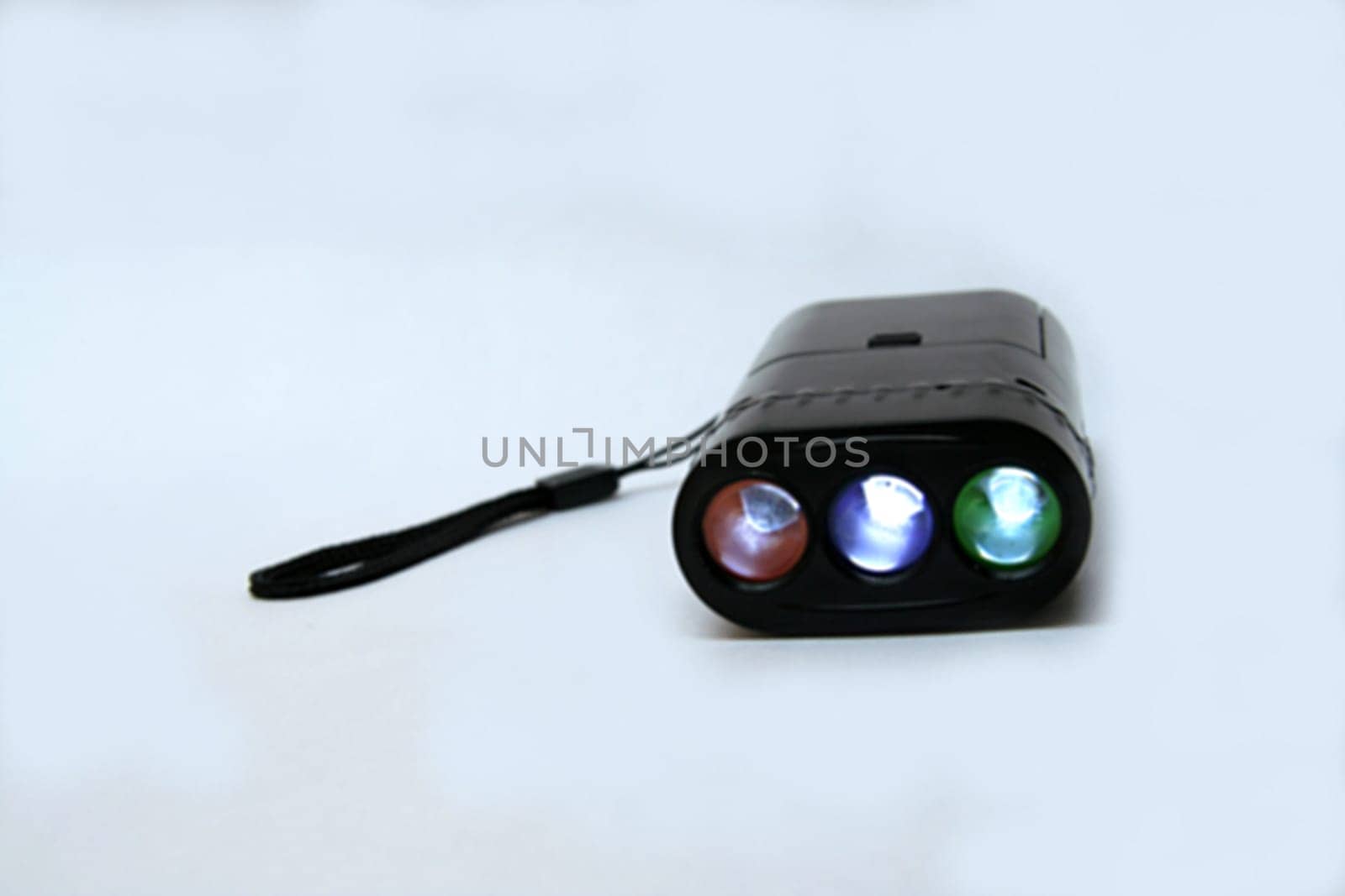 Miniature torchlight with triple lamps isolated on white background