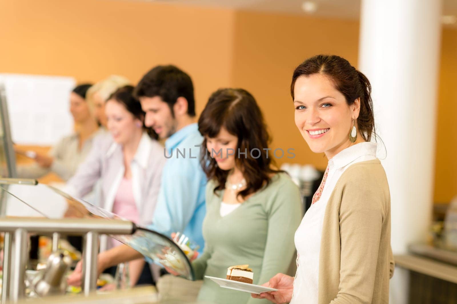 Cafeteria food young woman choose dessert self service buffet