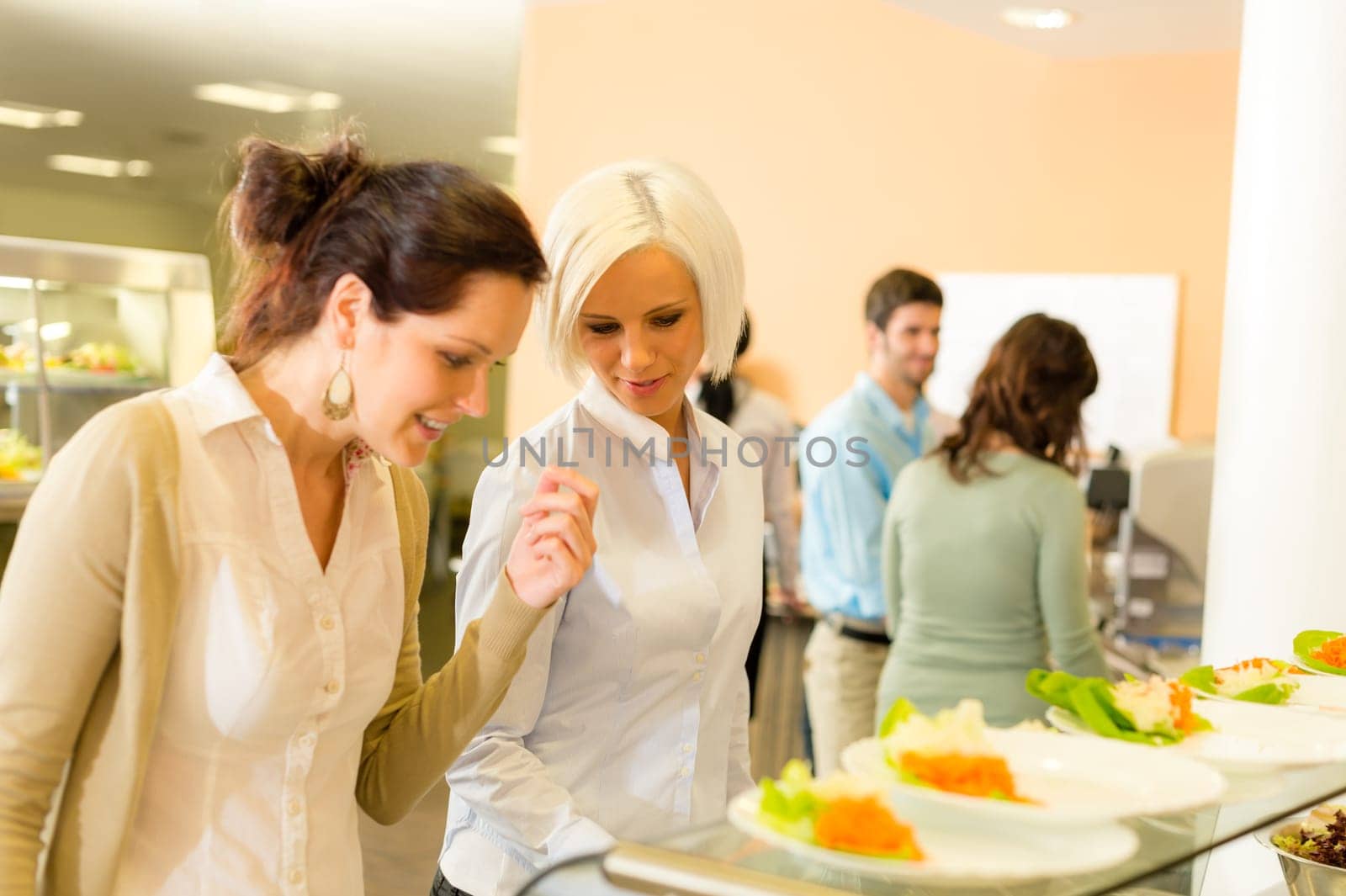 Lunch break business woman select meal from display cabinet canteen