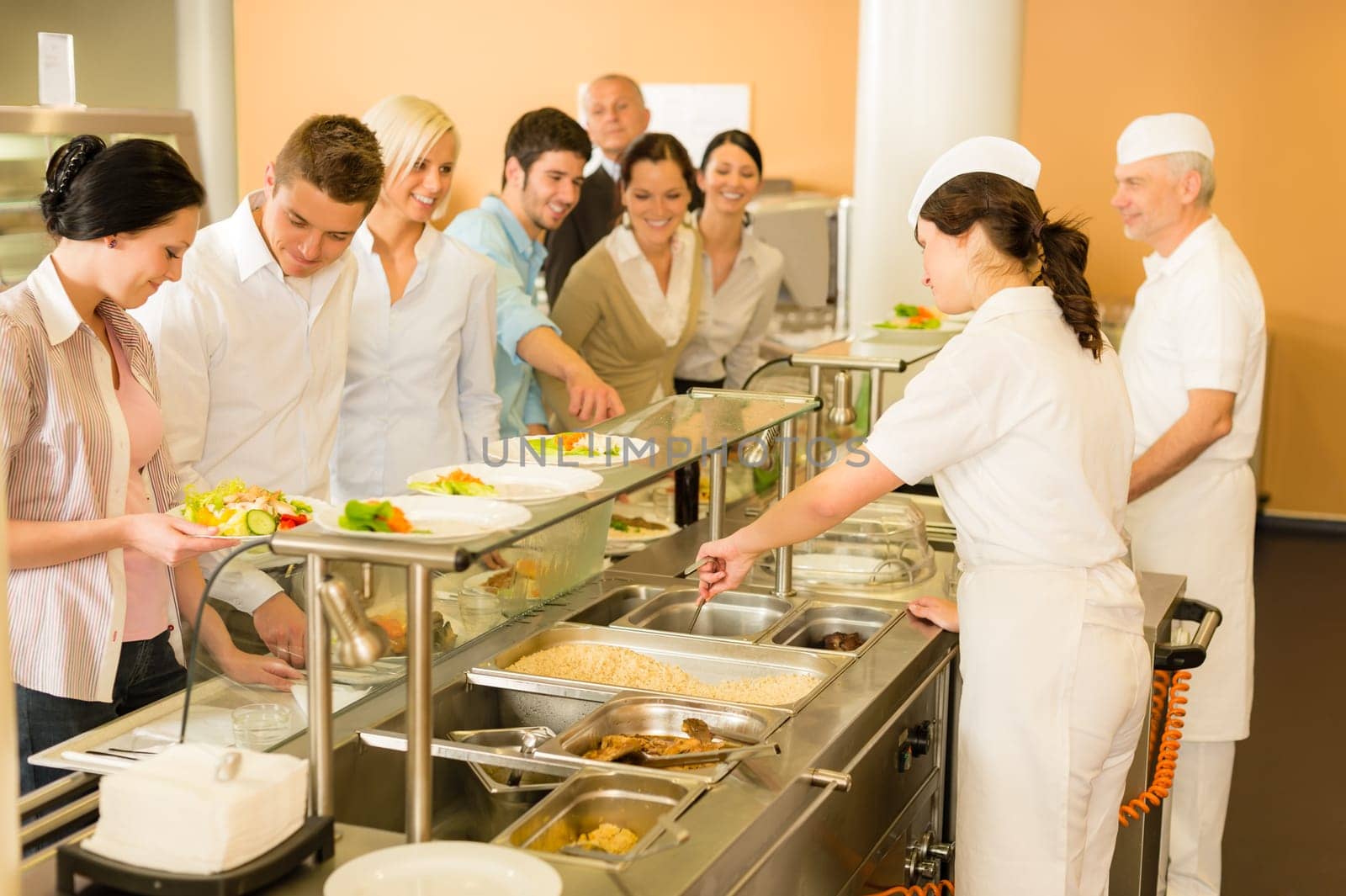Business colleagues in cafeteria cook serve fresh healthy food meals