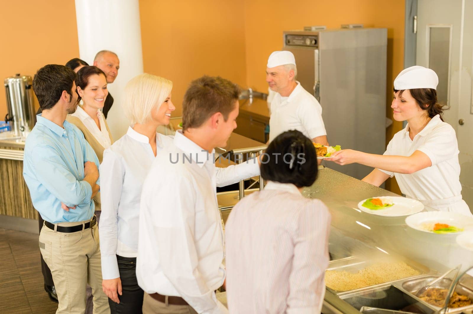 Business colleagues in cafeteria cook serve fresh healthy food meals