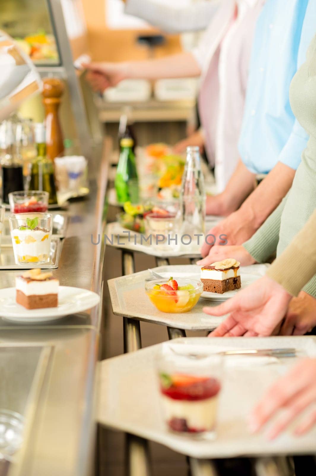 Desserts at cafeteria people with serving tray self service canteen