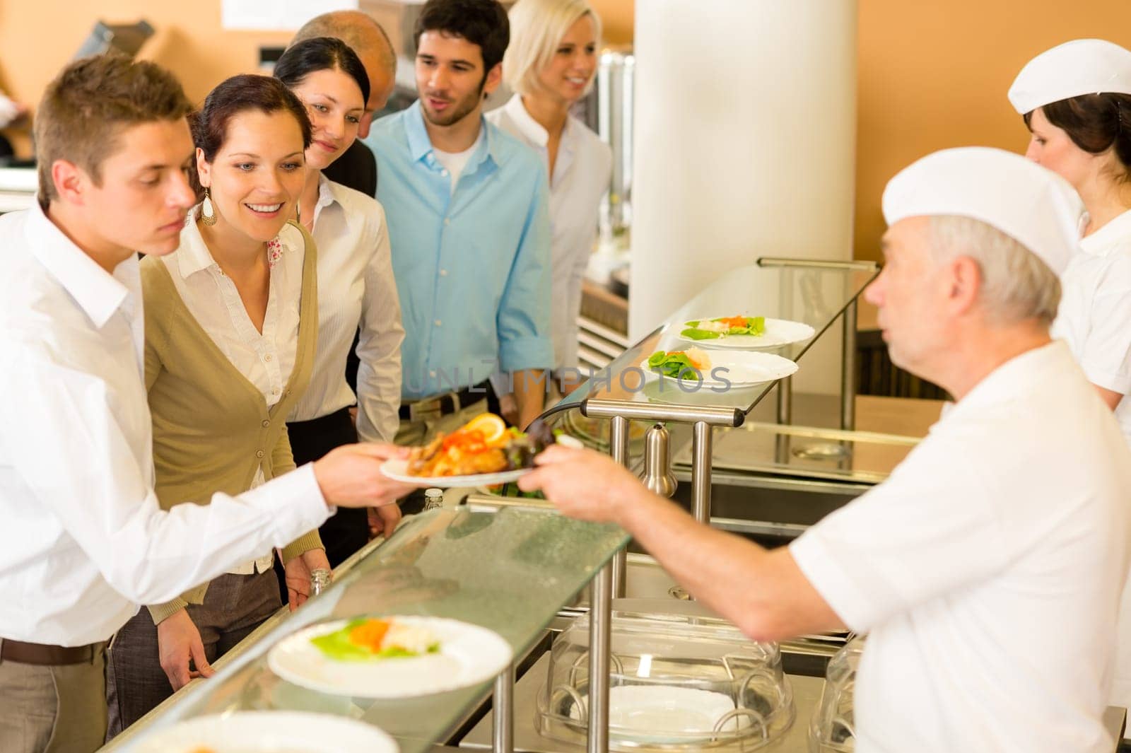Business colleagues in cafeteria cook serve fresh healthy food meals